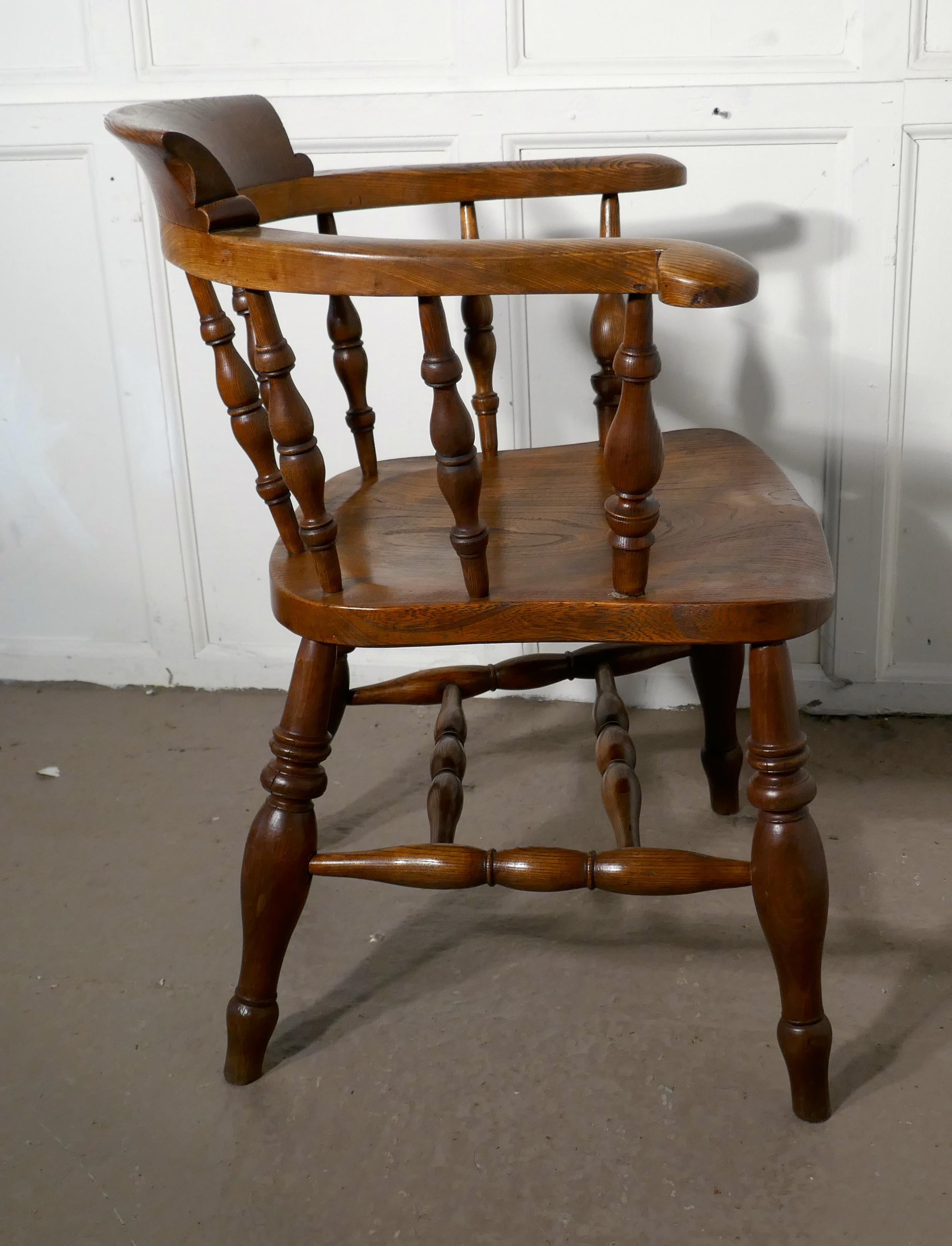 19th century elm and ash smokers bow office or desk chair

This solid chair has an attractive thick saddle shaped seat in Elm, it has a very wide curved top rail in Ash and chunky turned spindles beneath 

The chair stands on very attractive