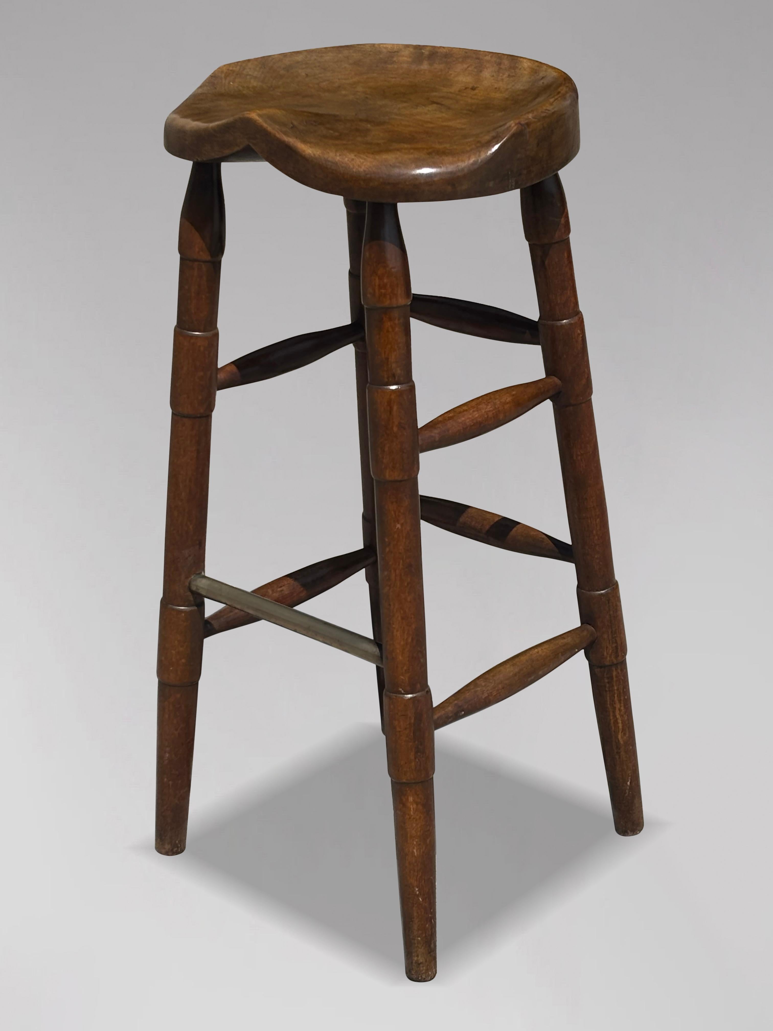 Charming Late 19th Century Tall Artist's or Bar Saddle Stool with Brass Foot Rest

This beautifully late 19th century crafted antique tall saddle stool combines rustic charm with practical comfort. A most comfortable elm high stool with a deep