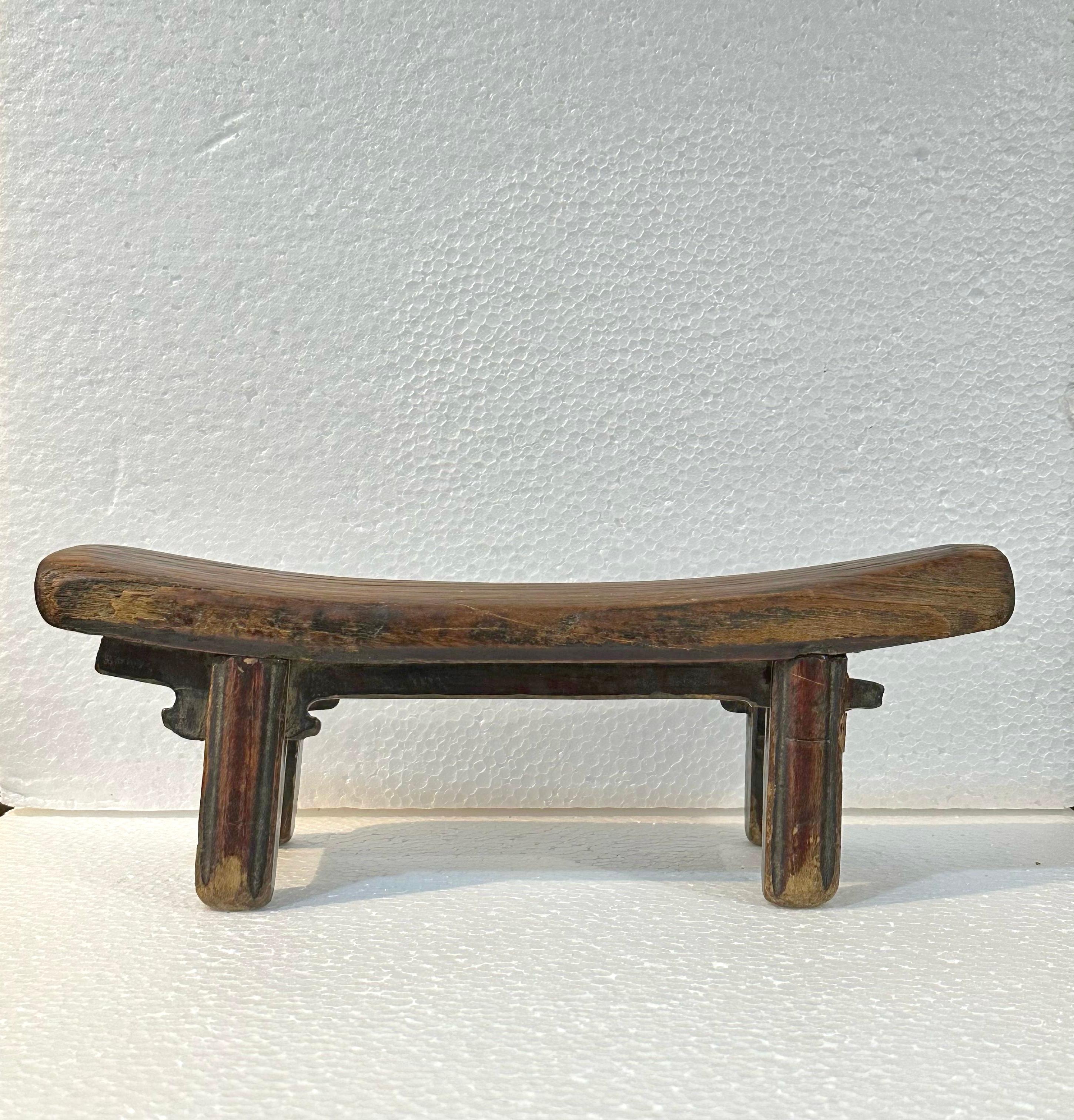 This wooden pillow from Shanxi takes the form of a traditional Chinese bench, beautifully miniaturized with a gently curved top surface for resting one's head. What is special about this piece is the meticulous attention paid to the decorative