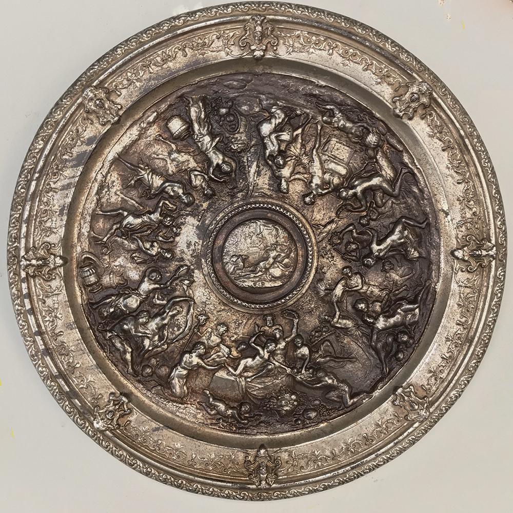 19th Century Silver Plated Cast Iron Charger depicts stunning Renaissance-inspired allegorical motifs in the round, with intricate bordering, all boldly embossed in bas relief. Originally silver plated, some of which is still evident.

circa