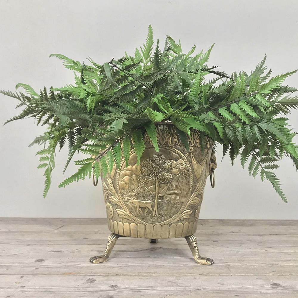 19th century embossed brass Jardiniere with lion's paw feet and lion heads with rings for handles, makes a wonderful accent piece all by itself, especially when filled with fresh flowers or fruit,
circa 1860s
Measures: 11.5 Height x 11.5 in