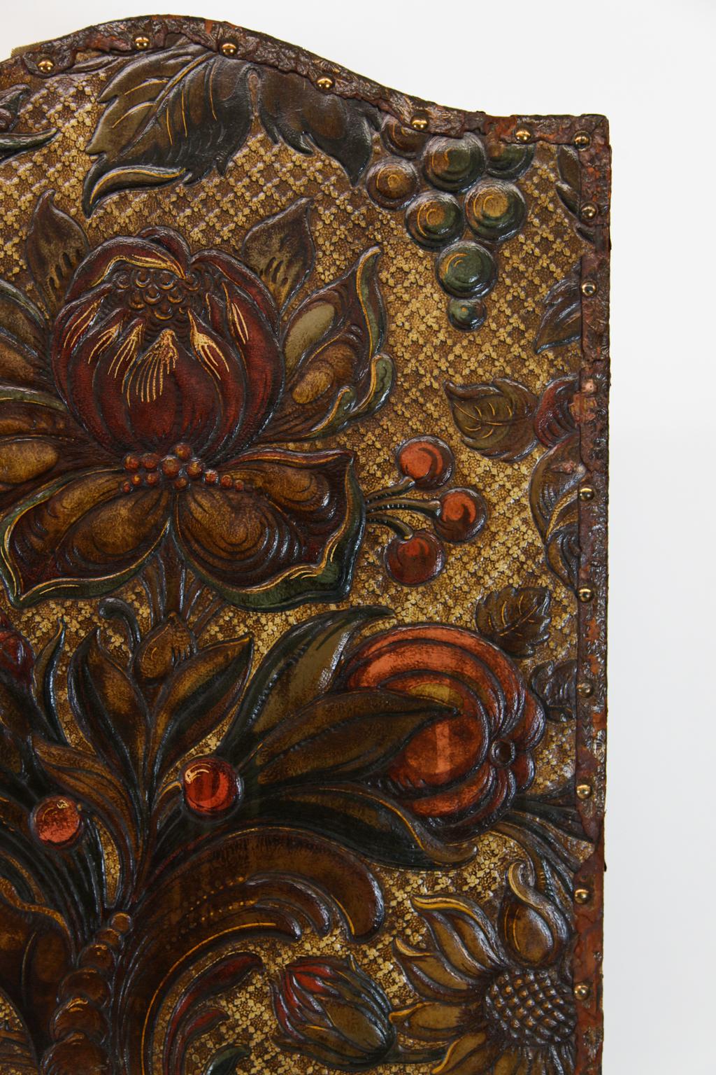19th century embossed leather four fold screen, with a myriad of multi-color floral and foliate designs.