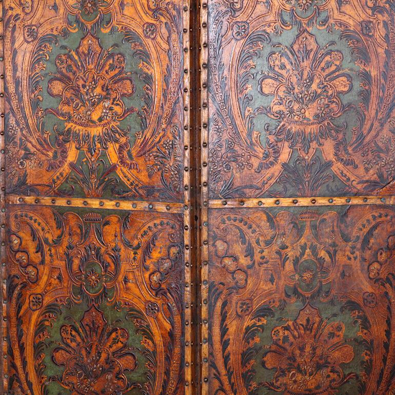 Highly decorative 19th century Spanish or Italian four-panel embossed leather screen, each section with ornate Baroque-style details. C. 1880.



