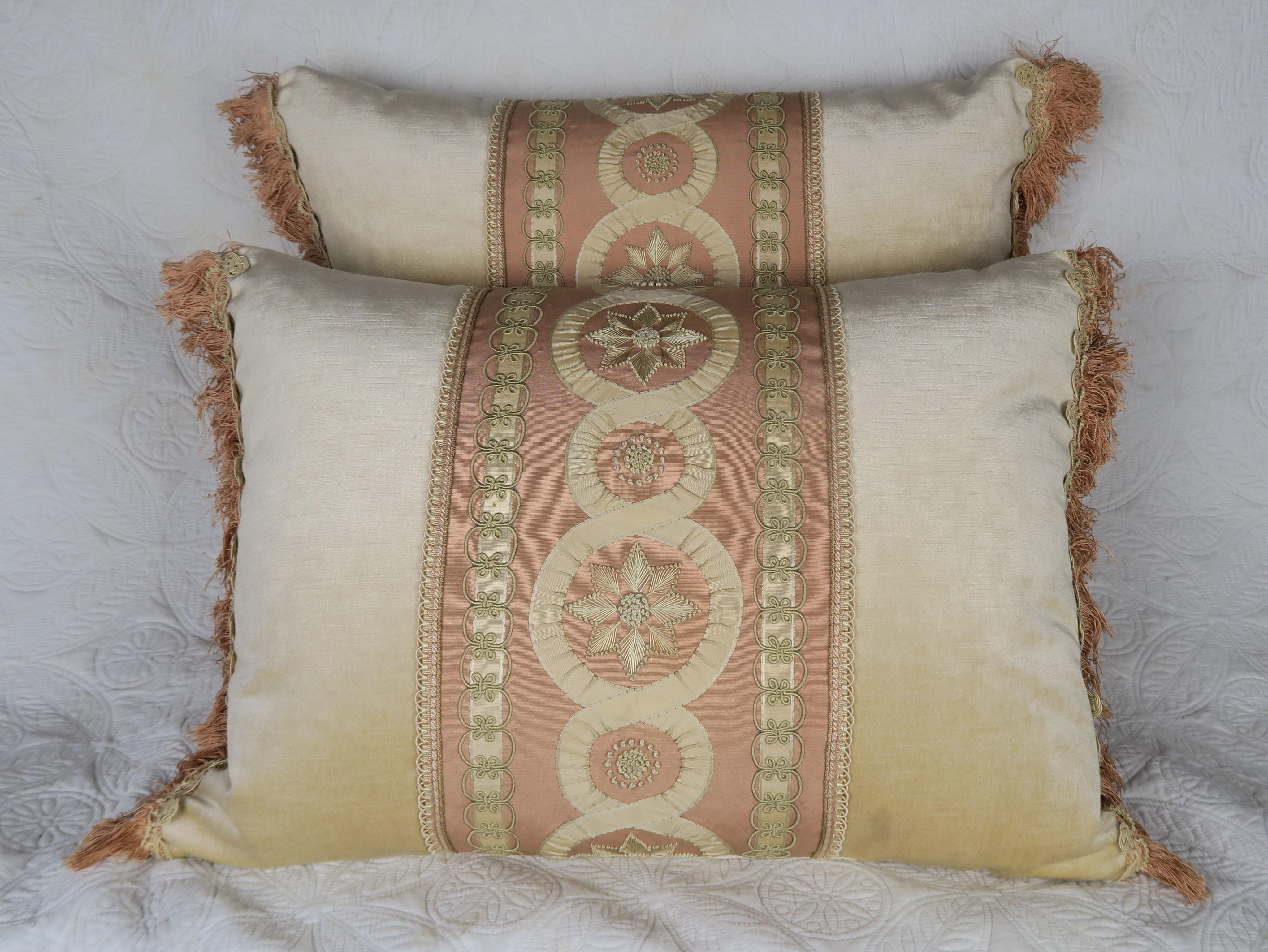 Pair of custom pillows made by Melissa Levinson using 19th century embroidered and appliqued silk panels that were combined with contemporary cream colored velvet fronts and backs. Antique trim is seen at sides of pillows. Down and feather inserts,