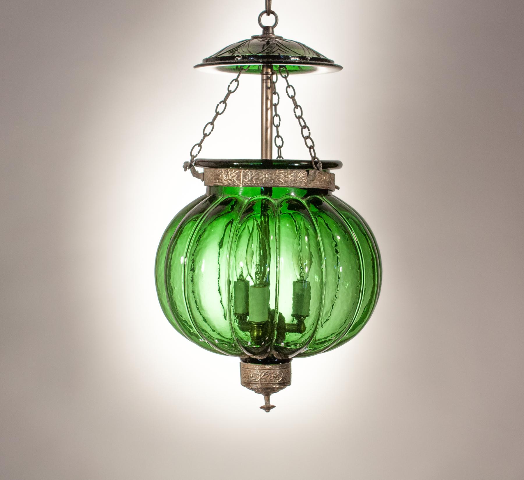 A rare 19th century Belgian green glass ribbed melon or pumpkin lantern hand blown in Belgium. This circa 1890 heirloom is in very good condition and has its original press glass smoke lid and brass details, including a canted finial (see image #11)