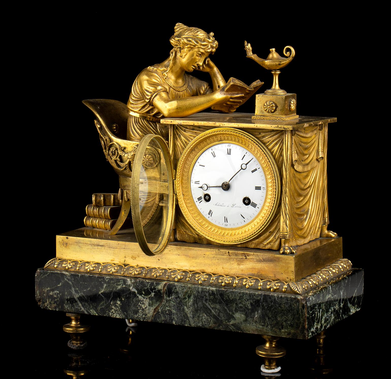 A Fantastic Mantel clock in Green marble and gilded bronze case with base, surmounted by a gilded bronze reading female figure, 