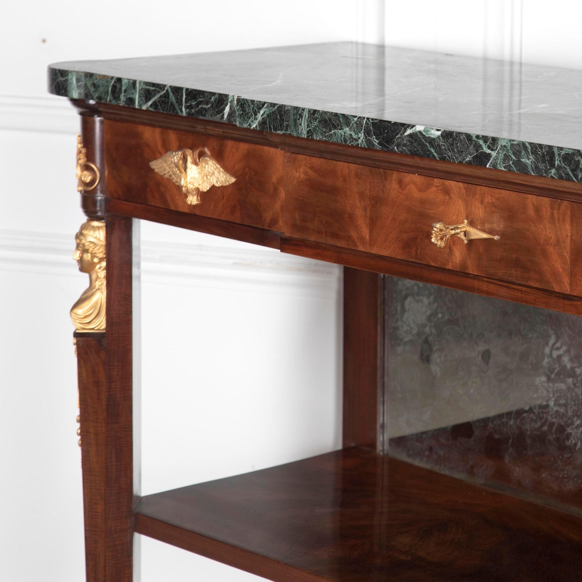 Very best quality Empire 19th century buffet.
This superb piece features gilt bronze mounts and gilt bronze feet. With a marble top featuring three drawers across the top and a very attractive veined green marble. Also features a mirror back to the