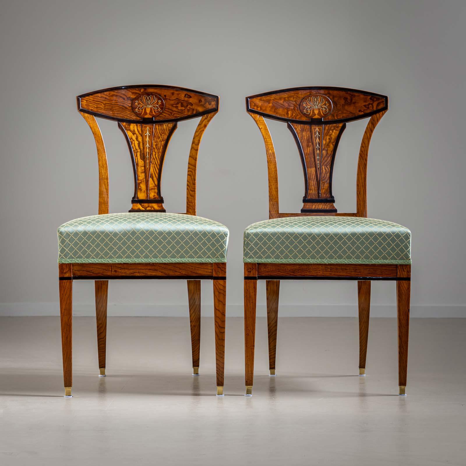 Elegant pair of Viennese chairs, the outstanding quality of the Empire chairs can be seen in the design of the backrest with floral bouquets and the finest brass inlays.