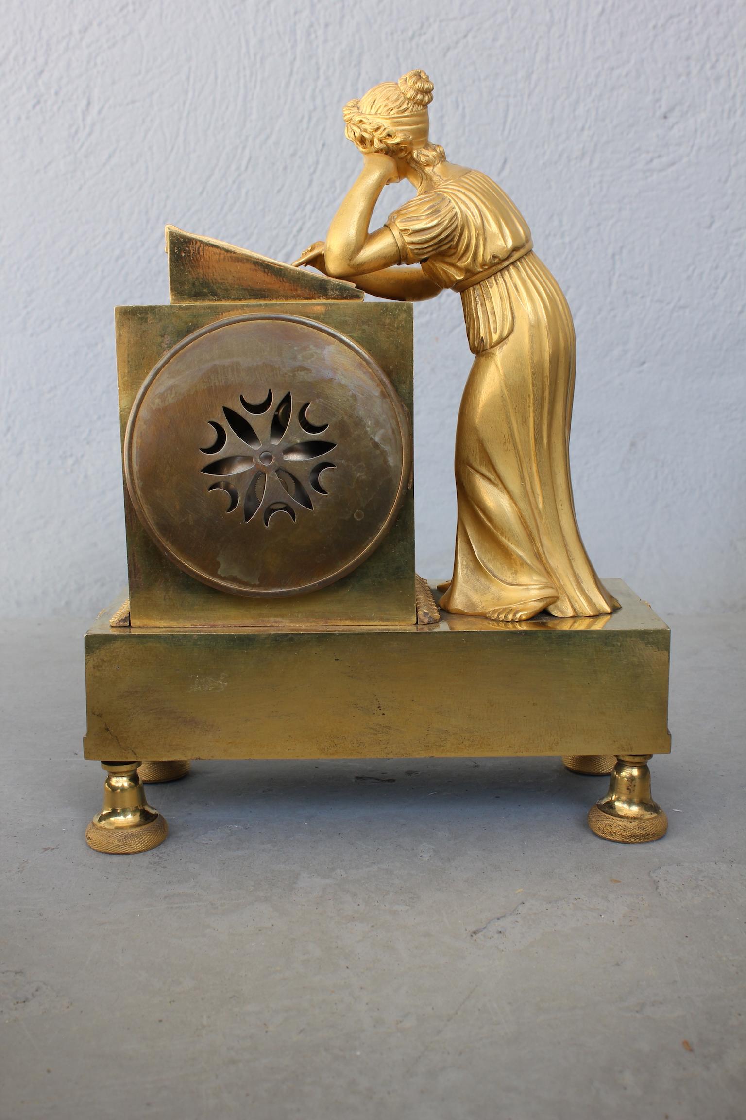 Gilt 19th Century Empire Clock Representing a Woman Writing For Sale