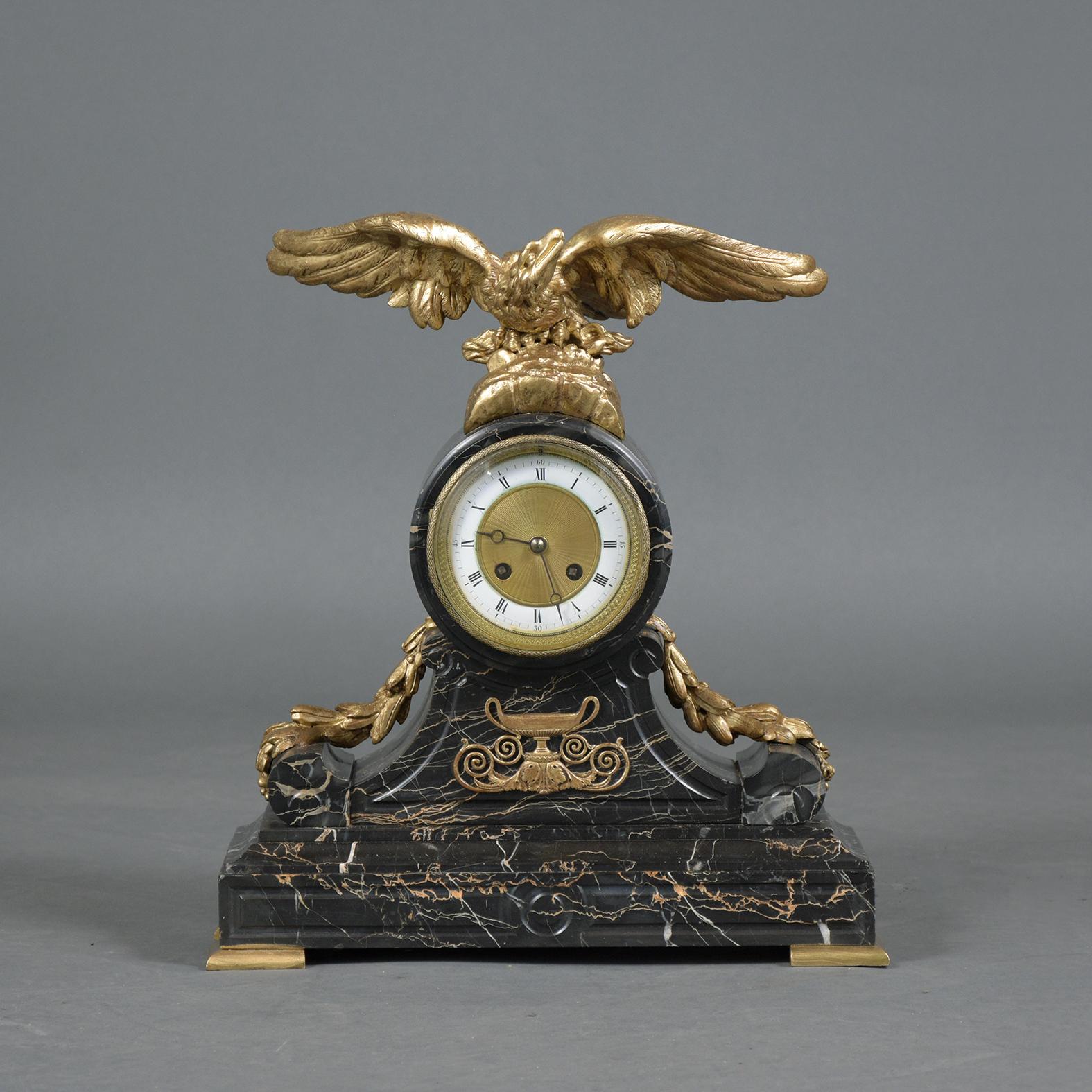 An extraordinary French 19th-century empire mantle clock, in working condition and beautifully crafted out of bronze and marble. This antique mantle clock is ready to be used and displayed for years to come.