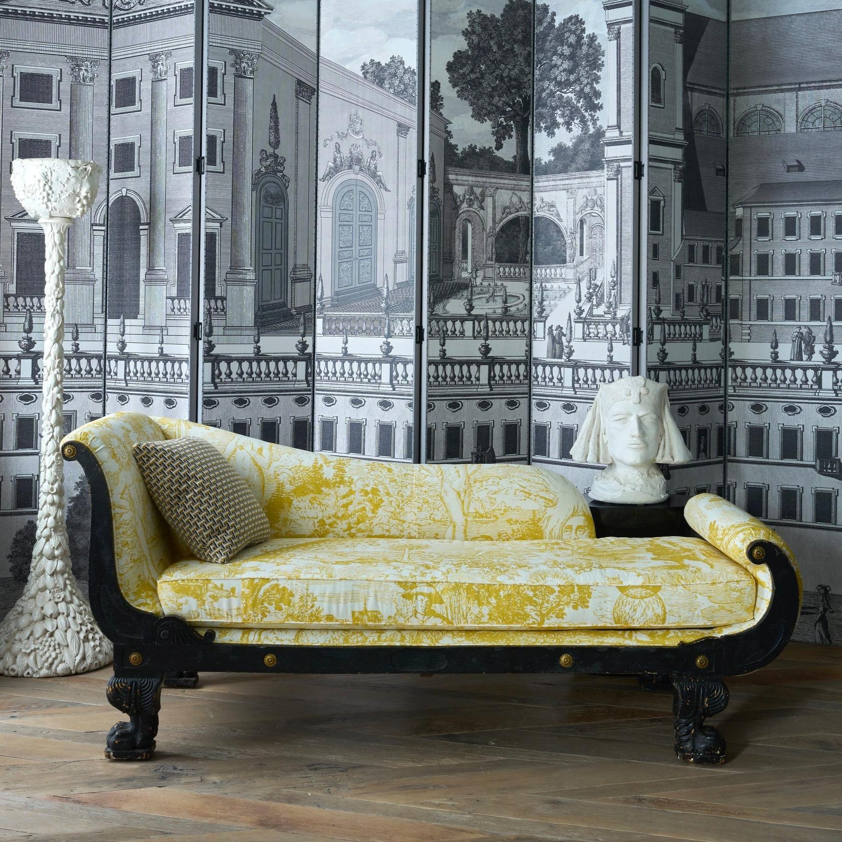A period 19th Century American Empire chaise newly upholstered in Schumacher Johnson Hartig Libertine Yellow Modern Toile Chaise. This heavy yellow and white cotton fabric is a layered, mystically-inflected toile based on Renaissance drawings and
