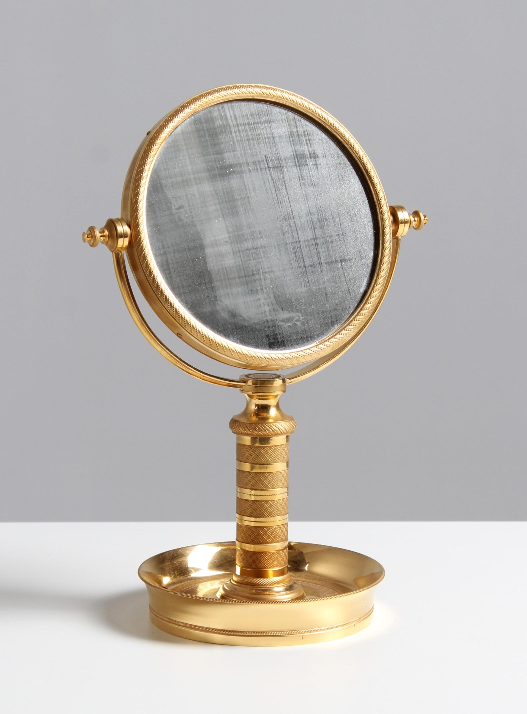 Antique table mirror

France
Bronze gilded
Empire, late 19th century

Dimensions: H x W x D: 34 x 24 x 16 cm

Description:
Extremely rare and very high quality made make-up mirror from the Second Empire period around 1890.

The round base with 16 cm
