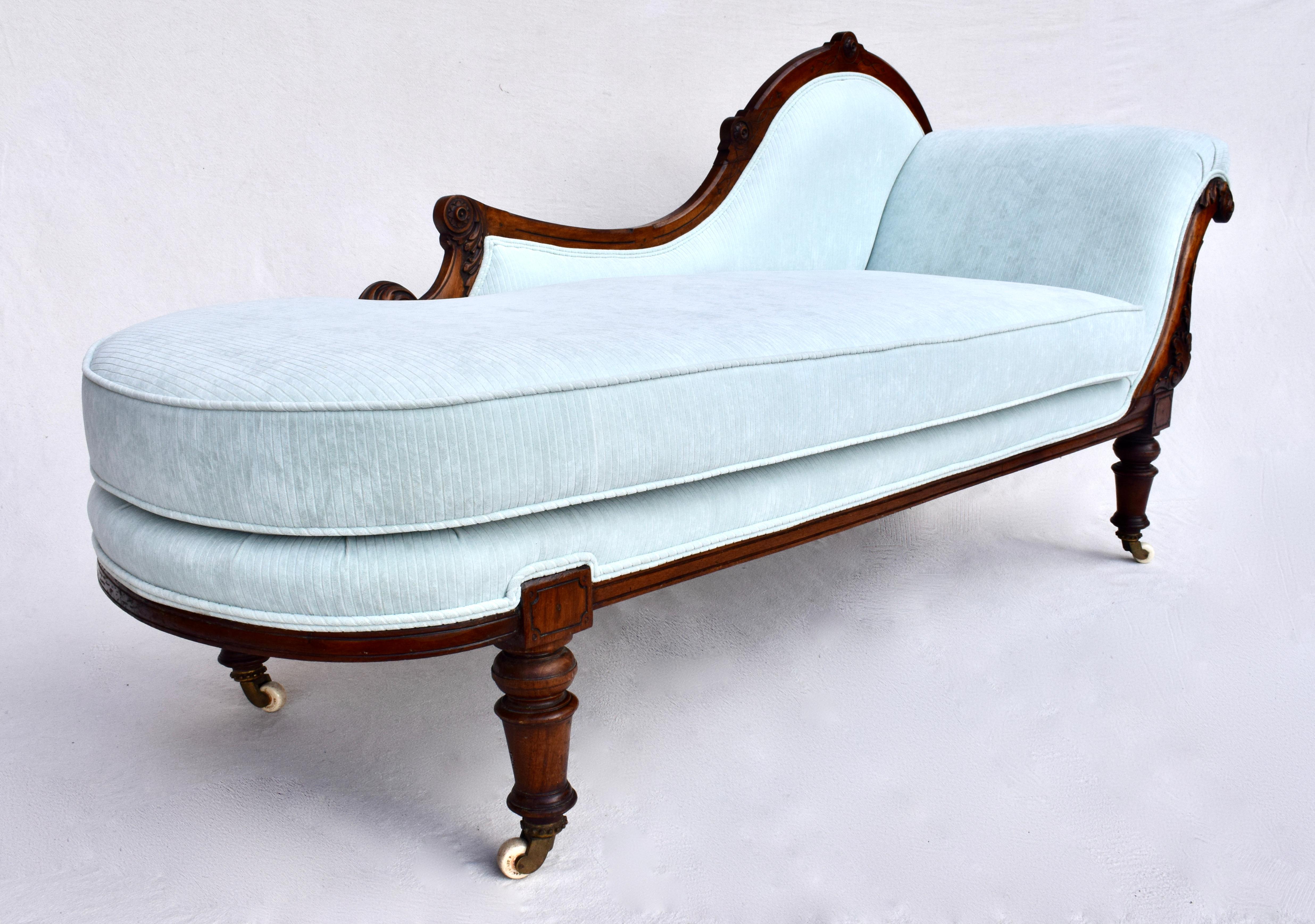 An exquisite 19th Century Empire Meridienne or Recamier of carved hand rubbed Mahogany featuring fully restored & re- glued construction newly upholstered in powder blue striped velvet with original porcelain casters.. Seat: 20