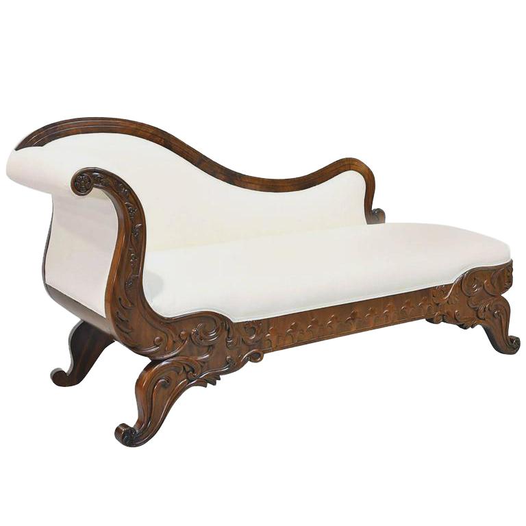 An exceptionally beautiful Karl Johan meridienne or fainting couch with graceful curves and foliate and fleur-de-lis carvings on the mahogany frame, with upholstered back, seat and sides, Sweden, circa 1830. Also known as a 