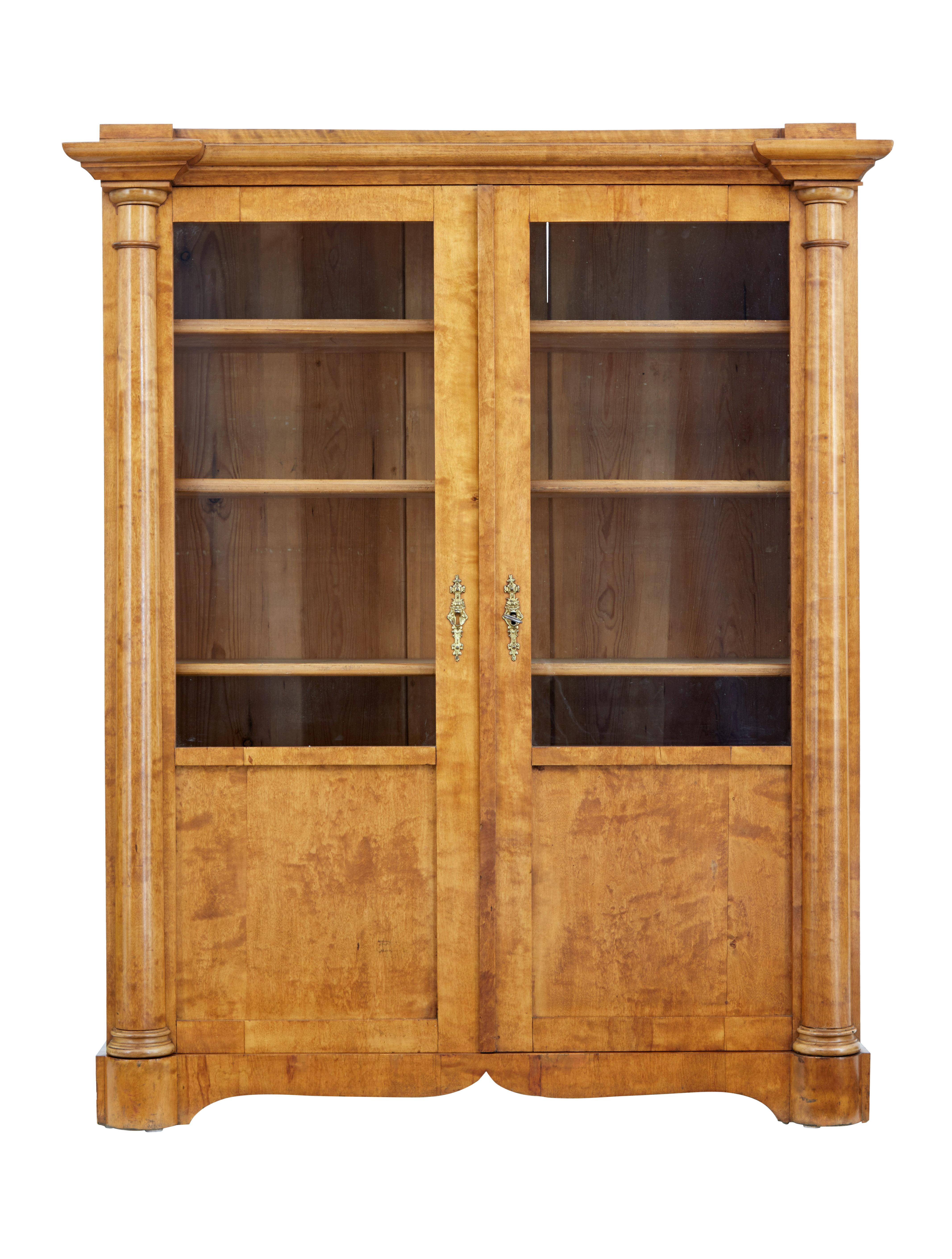 Elegant piece of Empire revival furniture, circa 1880.

Breakfront top surface which leads down to the turned columns which form the main feature each side of the piece. Part glazed double doors open to reveal an interior of 4 adjustable