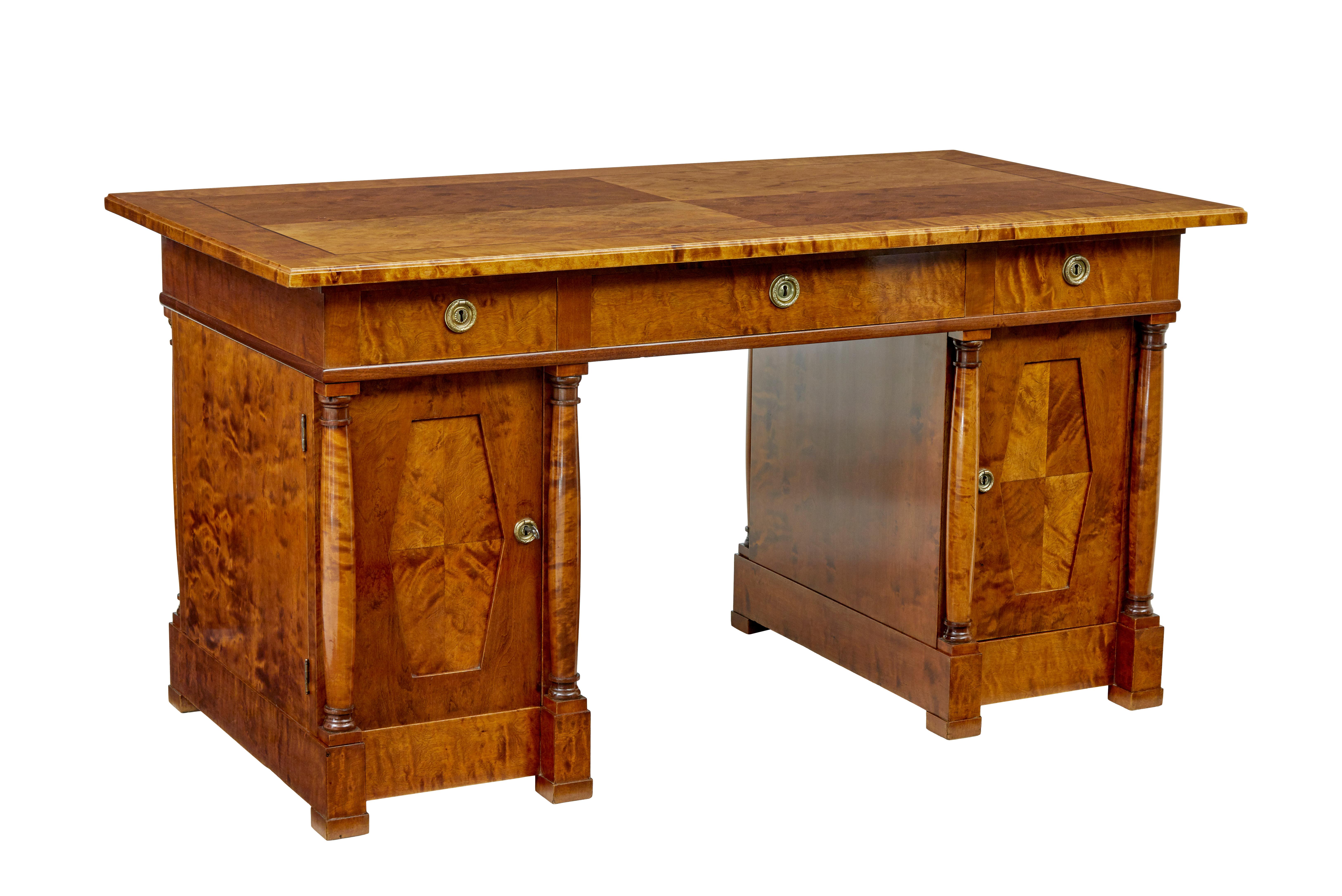 19th century empire revival Swedish birch desk circa 1895.

We are pleased to offer this stunning desk which has been fully restored in our workshop.

Rich golden colour, 3 part pedestal desk.  Top surface veneered in figured birch, detailed with