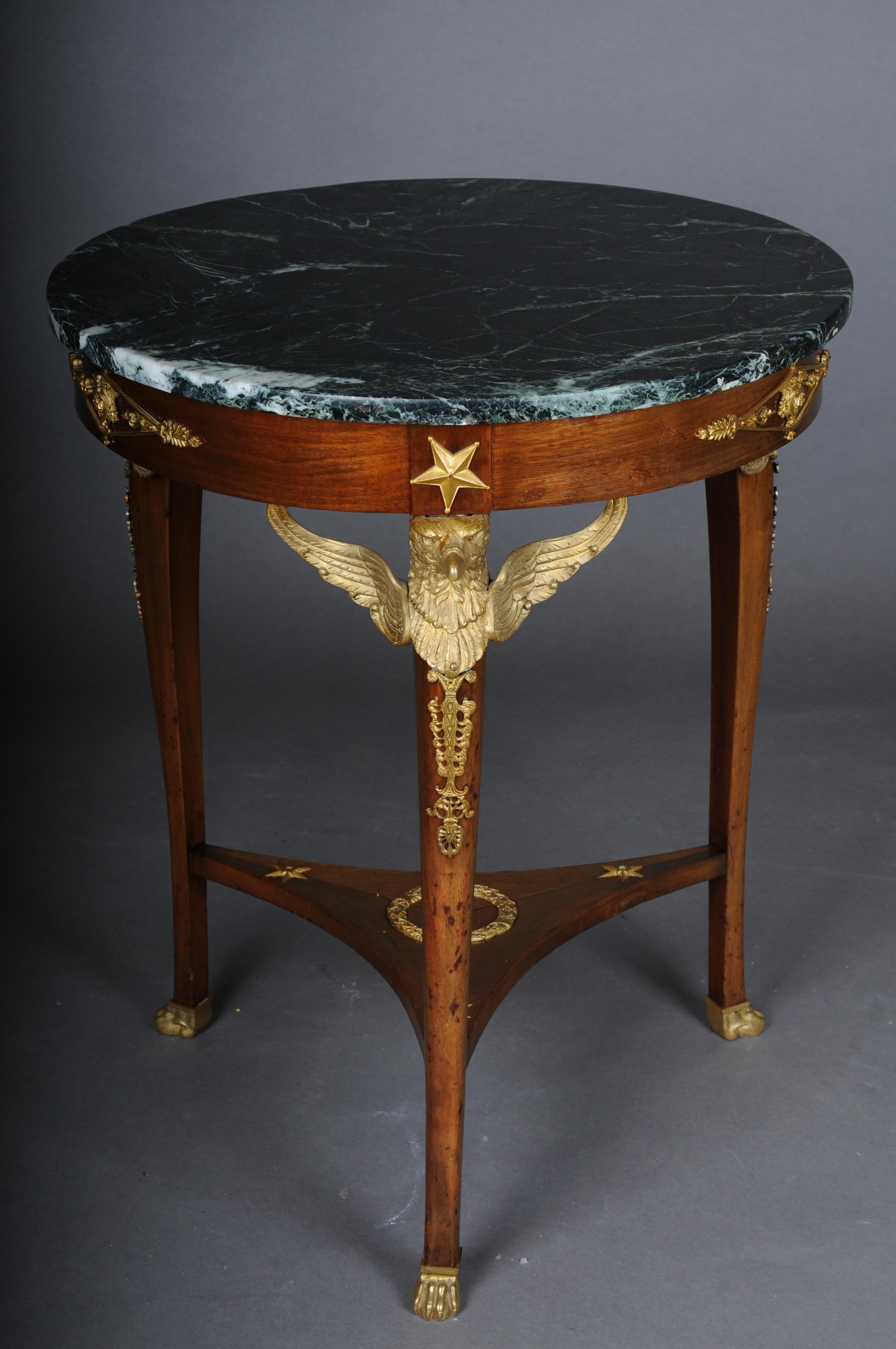 19th Century Empire side table, gilt bronze, eagle, mahogany, Paris

Impressive Empire side table, round top with mottled marble top. Exceptionally finely crafted table with chased and gilded bronze fittings. Body articulated on three legs, each