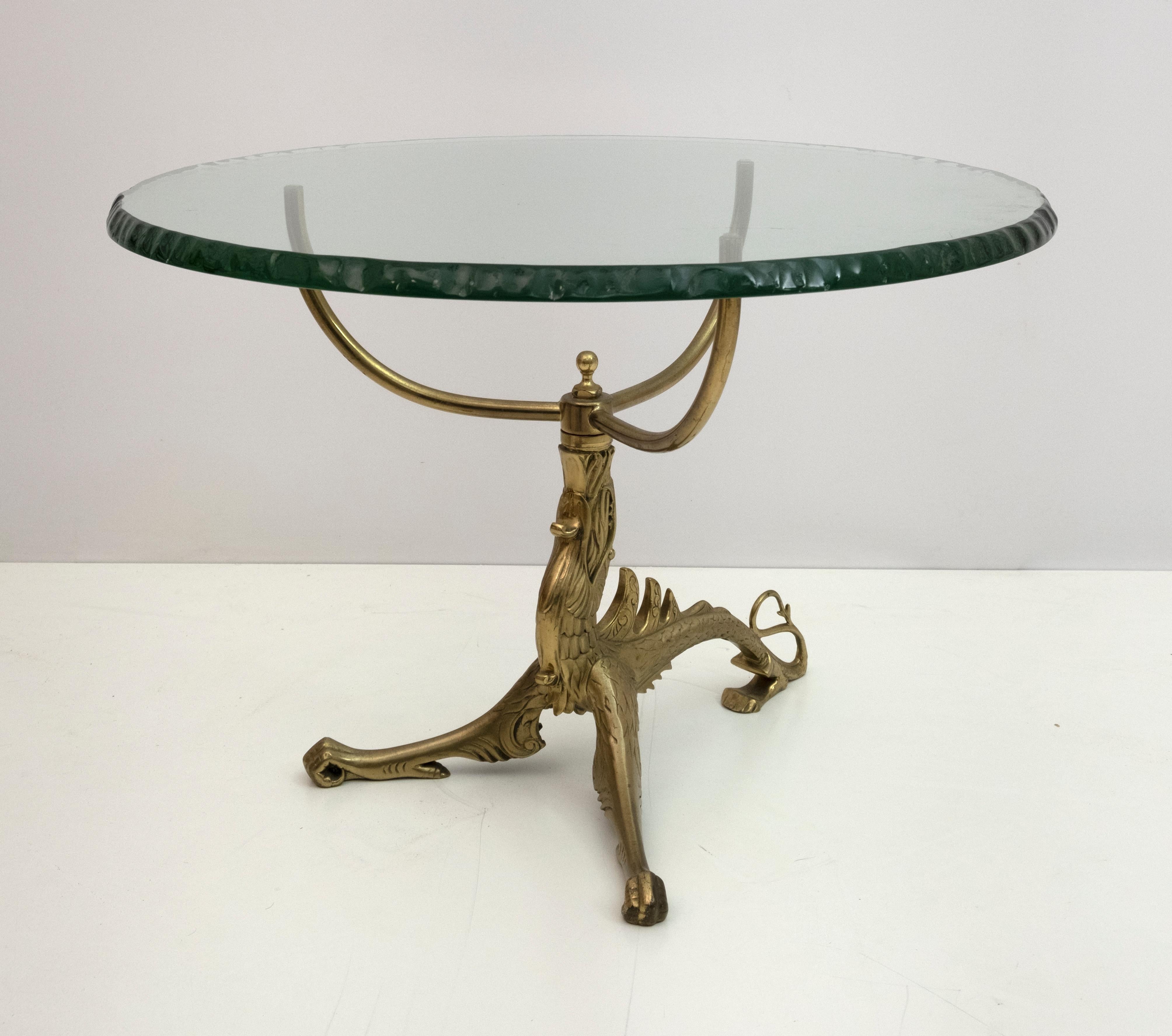 This Empire style coffee table, has as a base a gilded bronze casting, lost wax casting, depicting a dragon, the glass top has a thickness of two centimeters, the edge is hand chiseled, glass from the famous French company Saint-Gobain.

