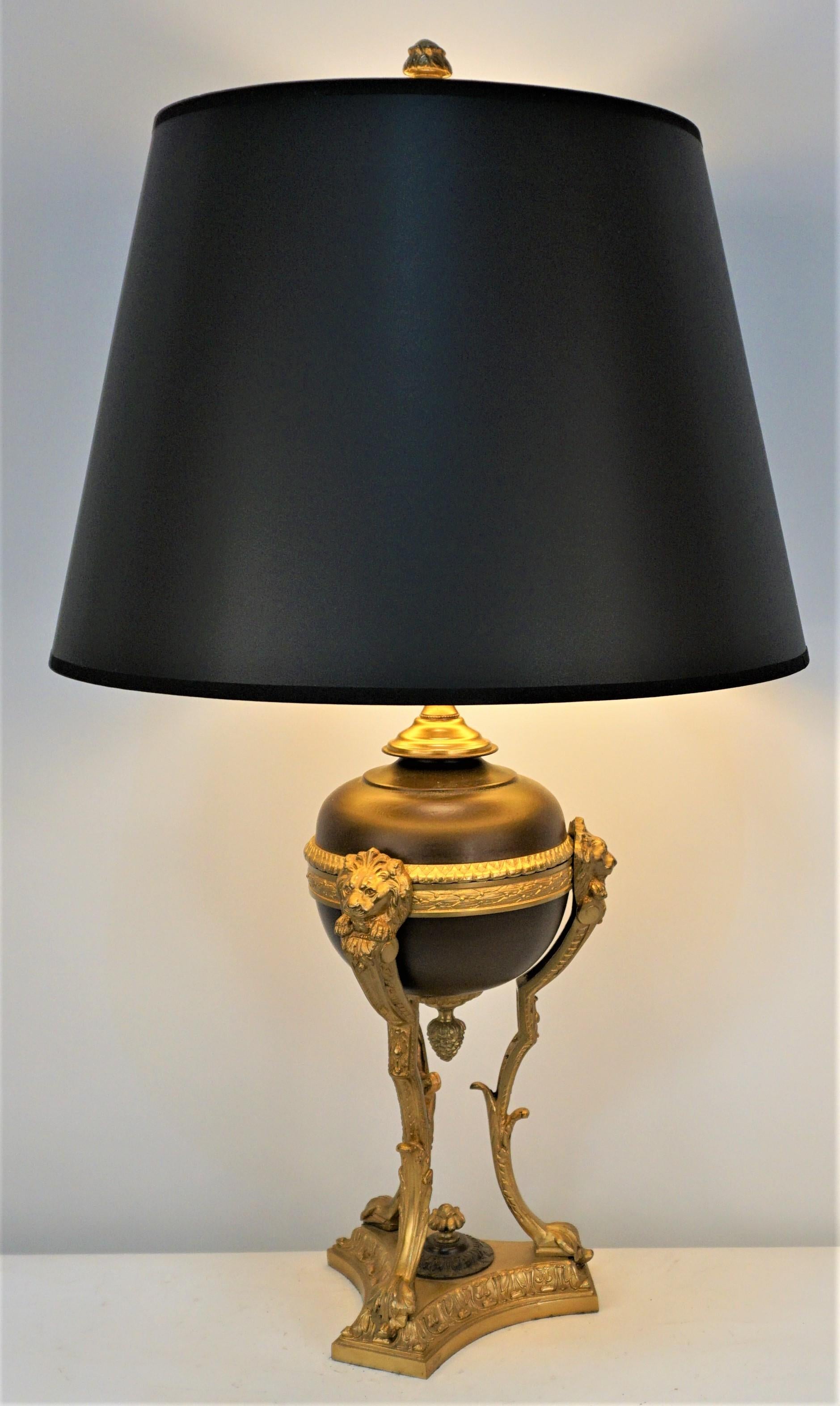 French Empire style Electrified bronze and brown lacquer on bronze oil lamp with three-way socket and fitted with silk lampshade.