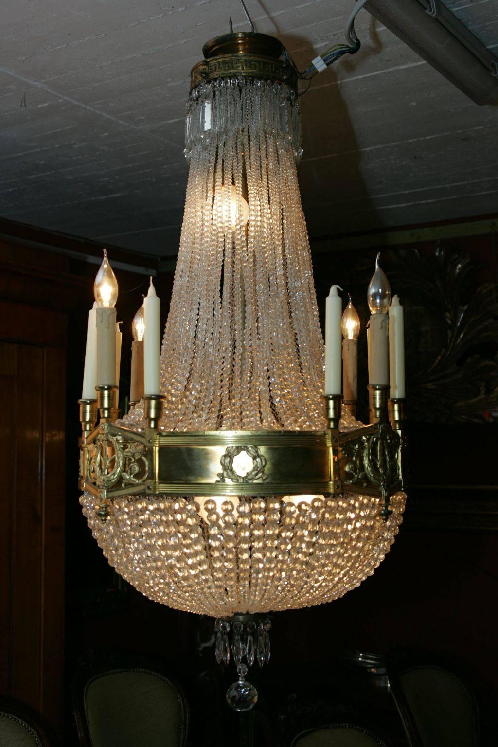 Antique Majestic basket chandelier in French. Empire style in 1900.
Bronze, gilded. Basket-shaped, profile-shaped body made of hand-cut French ball prism strings. In the course, connected by broad, ornamental relief hoop. Outgoing twelve