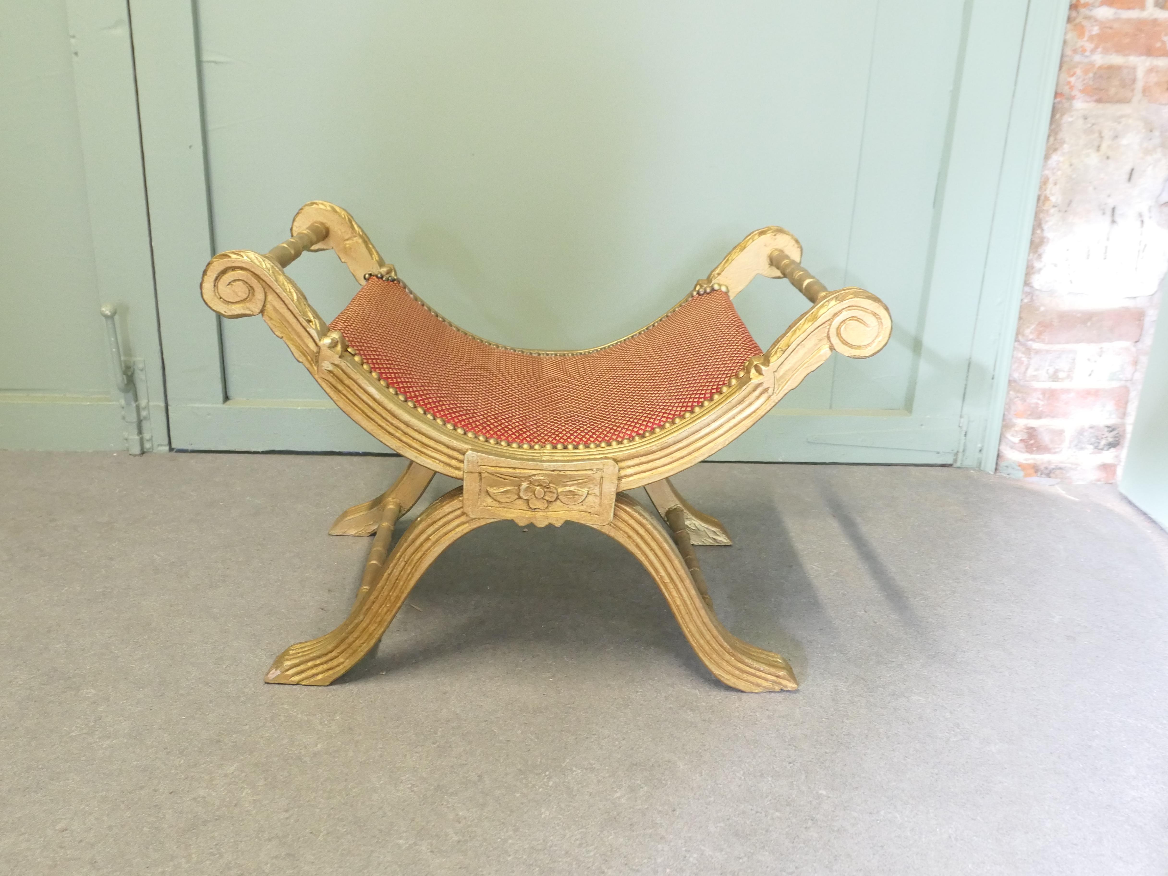 19th Century Empire Style Gilt X Frame Stool

A superb antique Neo-Classical X Frame stool in the Empire style, the stool has relatively new upholstery and the show wood is carved and gilded in the classical style
The stool is in good condition 
The