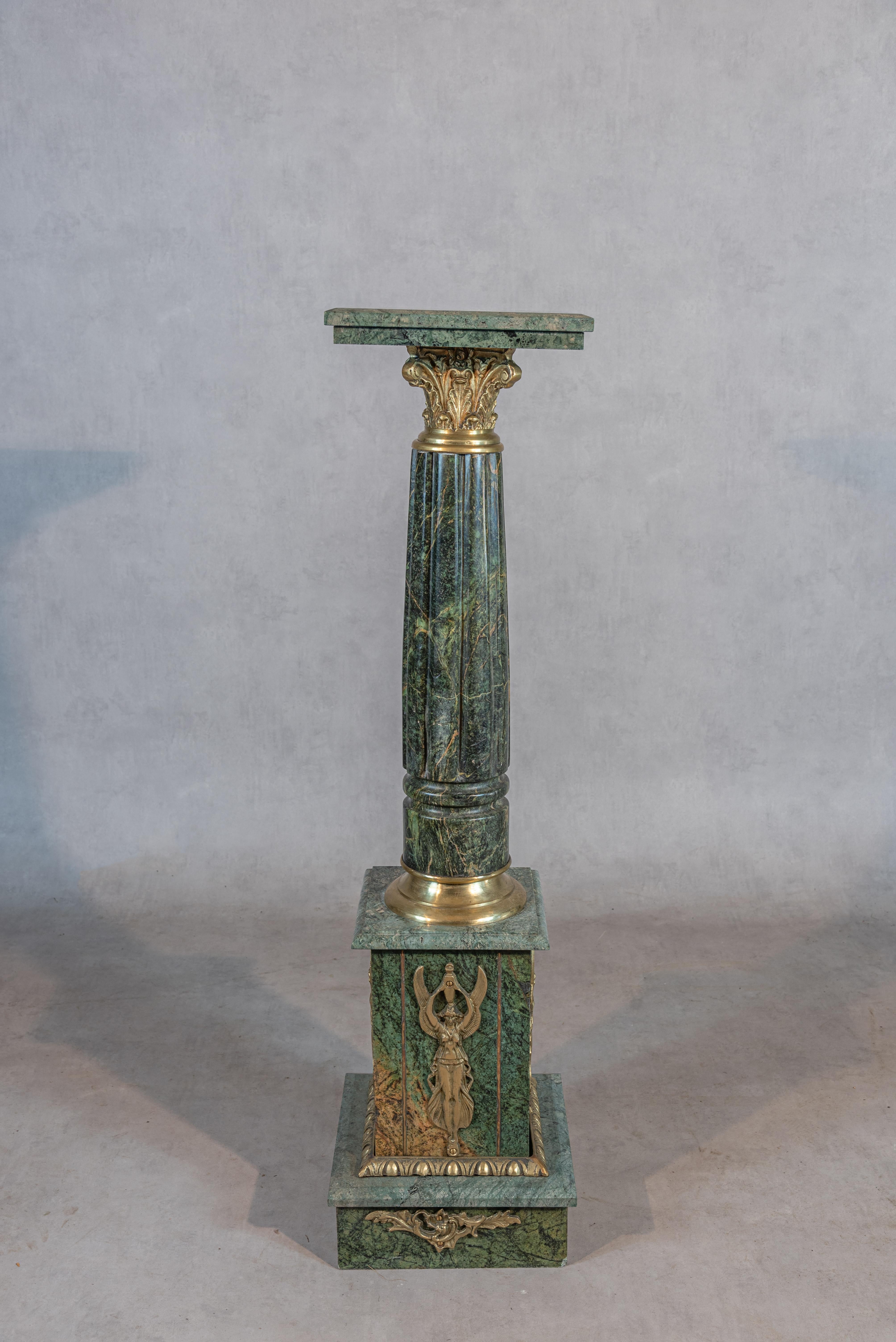 Experience the grandeur of the 19th Century Empire Style with this magnificent Green Marble and Brass Column. Crafted to perfection, this column exudes timeless elegance and regal charm, capturing the essence of the Empire aesthetic.

The rich