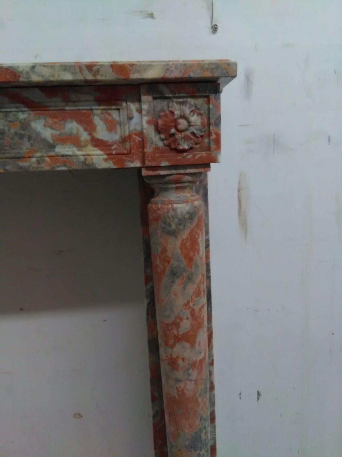 Petite French Empire with disengaged columns and rosette corner blocks. Carved in Incarnat Turquin Marble.

Opening dimensions: 33 1/2