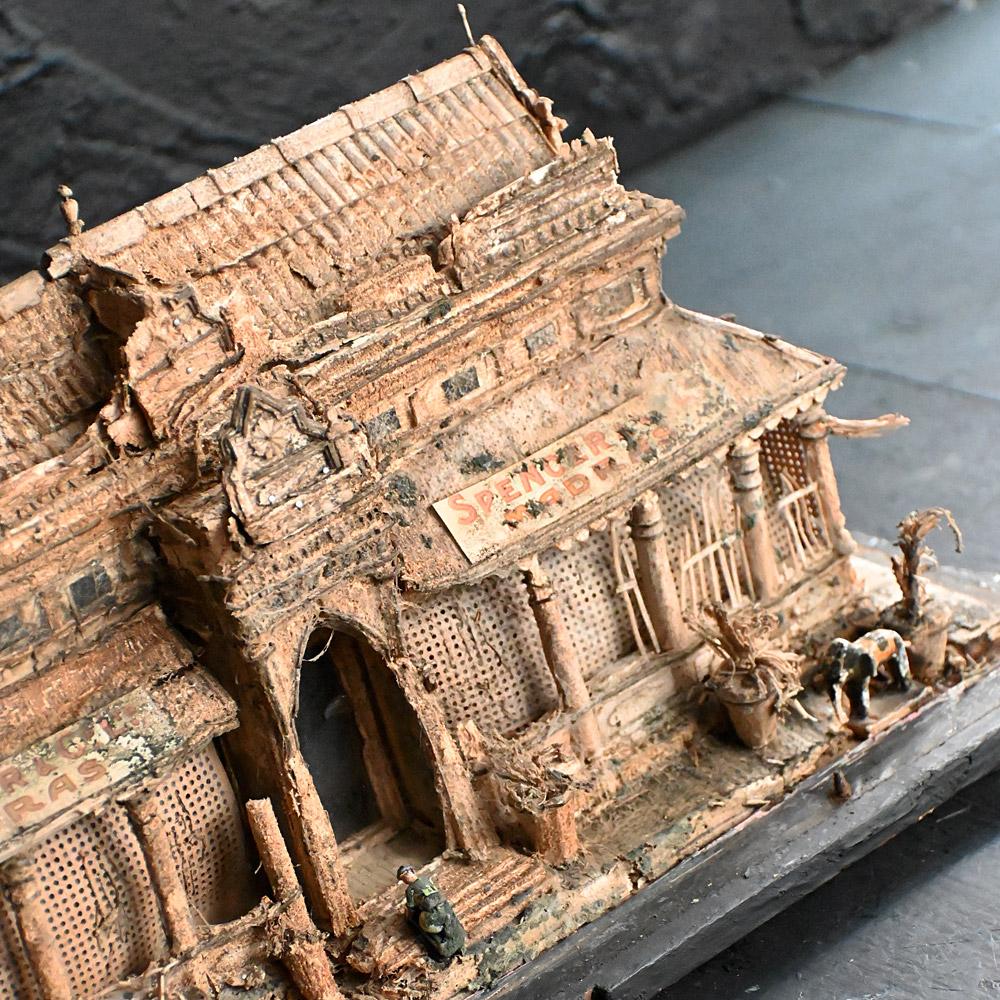 19th Century encased paper model of an Indian grocery store 
Quite simple this is an amazing decorative object, encased in a 19th century glass and pine display, a handmade paper model of an Indian grocery shop, with wooden hand painted elephant and
