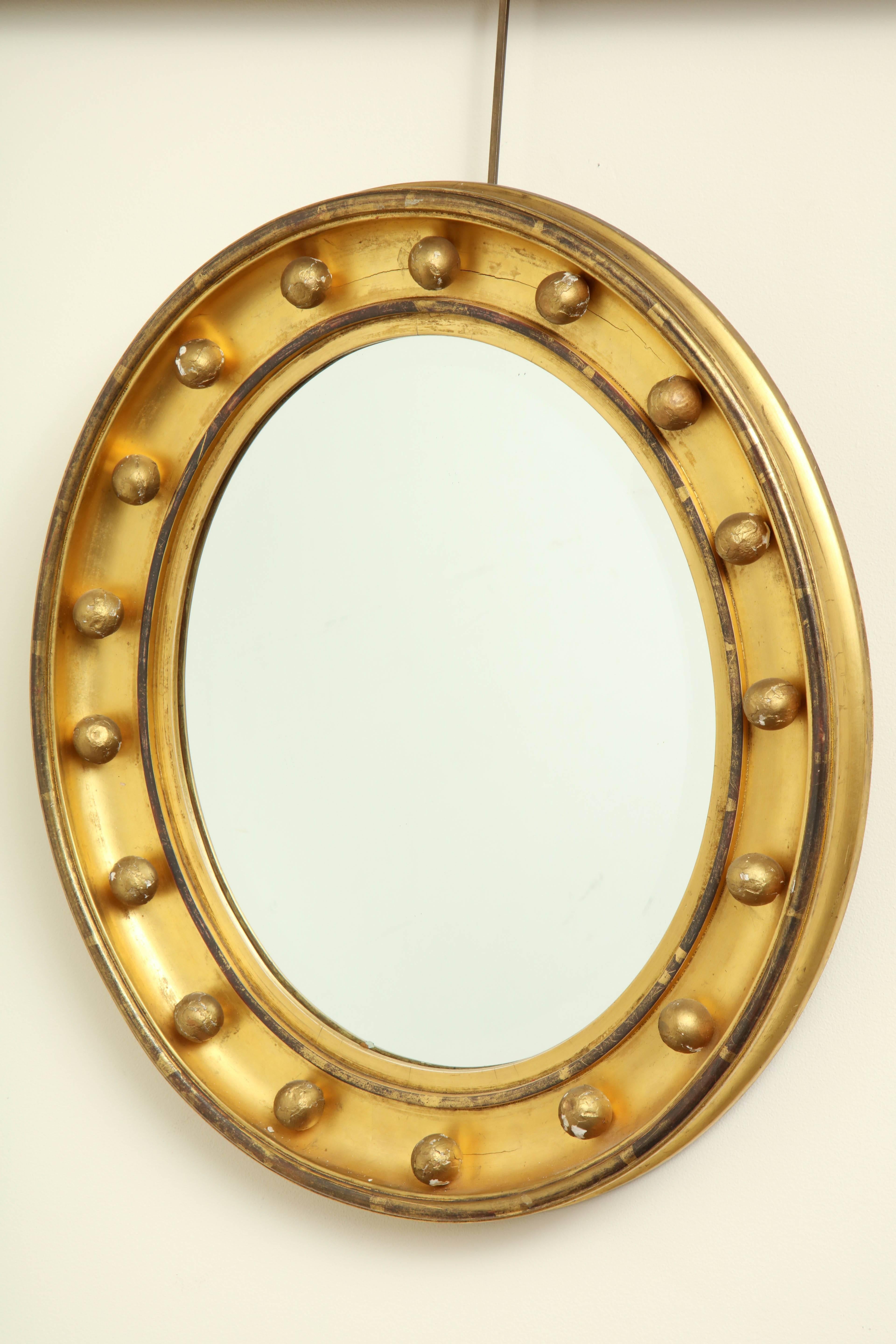 19th century English, beveled mirror in a gilded oval frame.