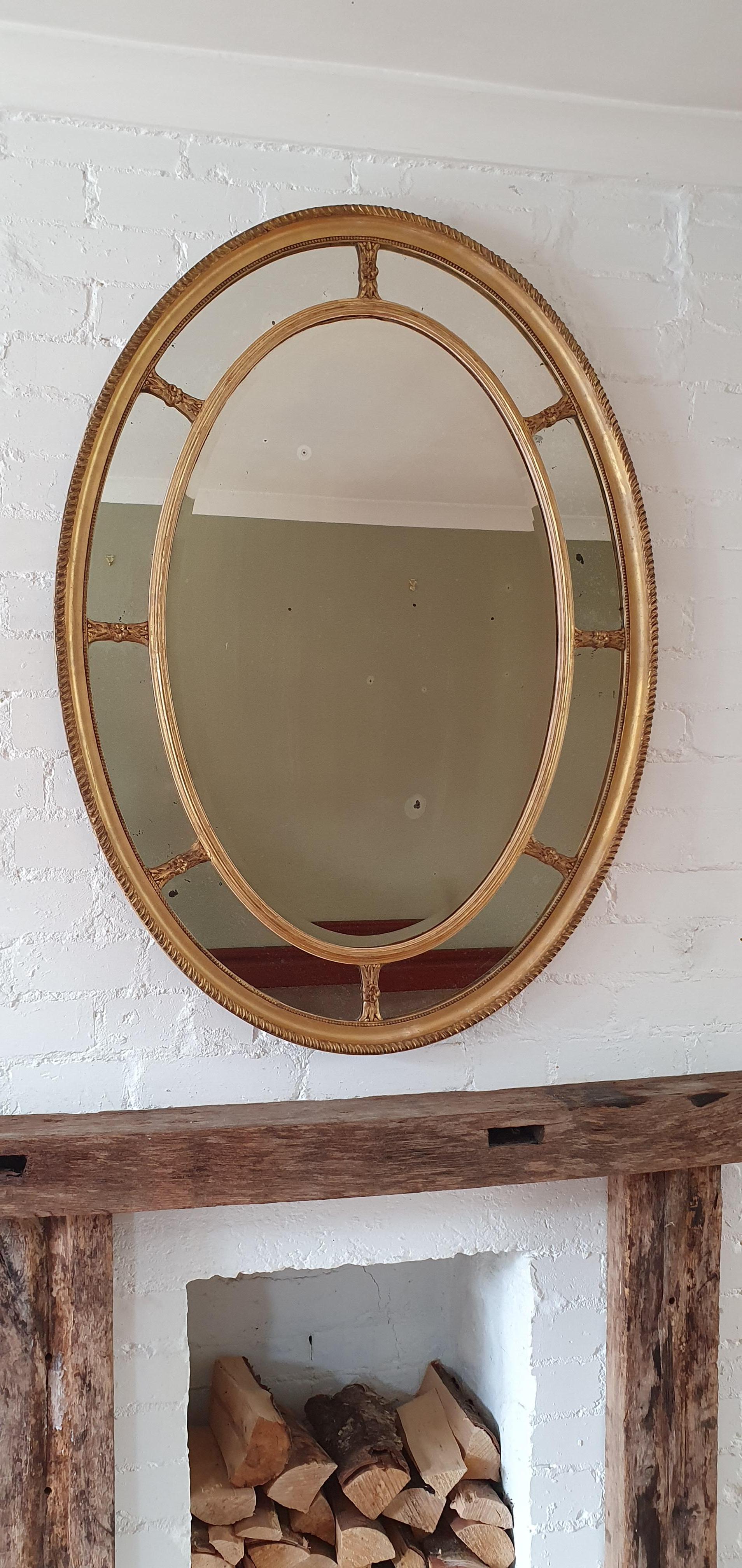 English giltwood and composition marginal wall mirror, Adam style circa 1890. Original gilding. Original mirror plate (center beveled), with signs of age ( black spots, scratches etc.