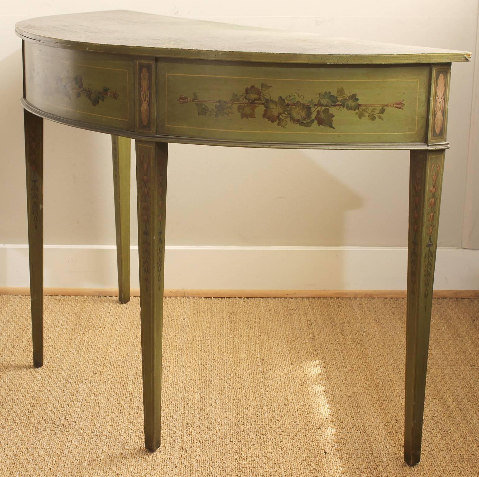 A 19th C. English paint decorated demilune console table in a lovely shade of green accented with trailing ivy, bellflowers and ribbons.  