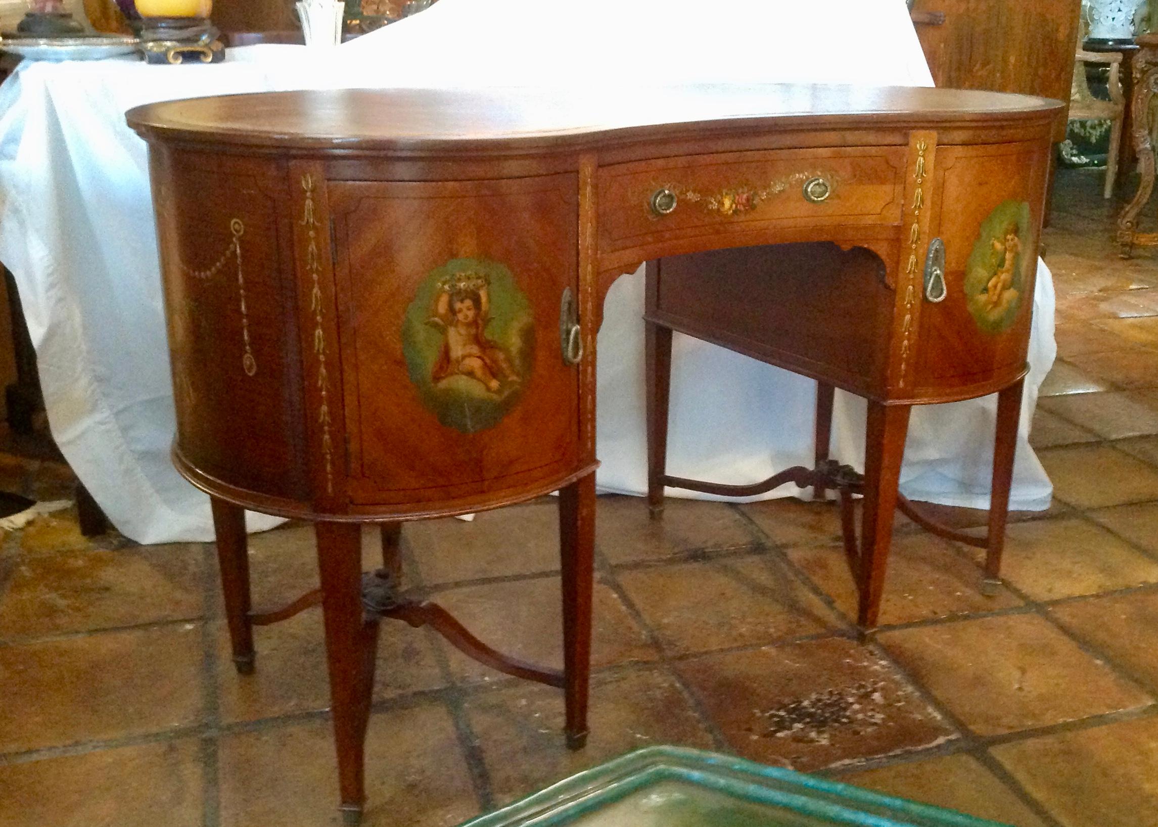 Superb quality, embellished with fine classic paintings.
Very nicely detailed with elaborate twin cross stretches and appointed
with a lather top. The drawer is finished with dust liners.
Desirable kidney form.