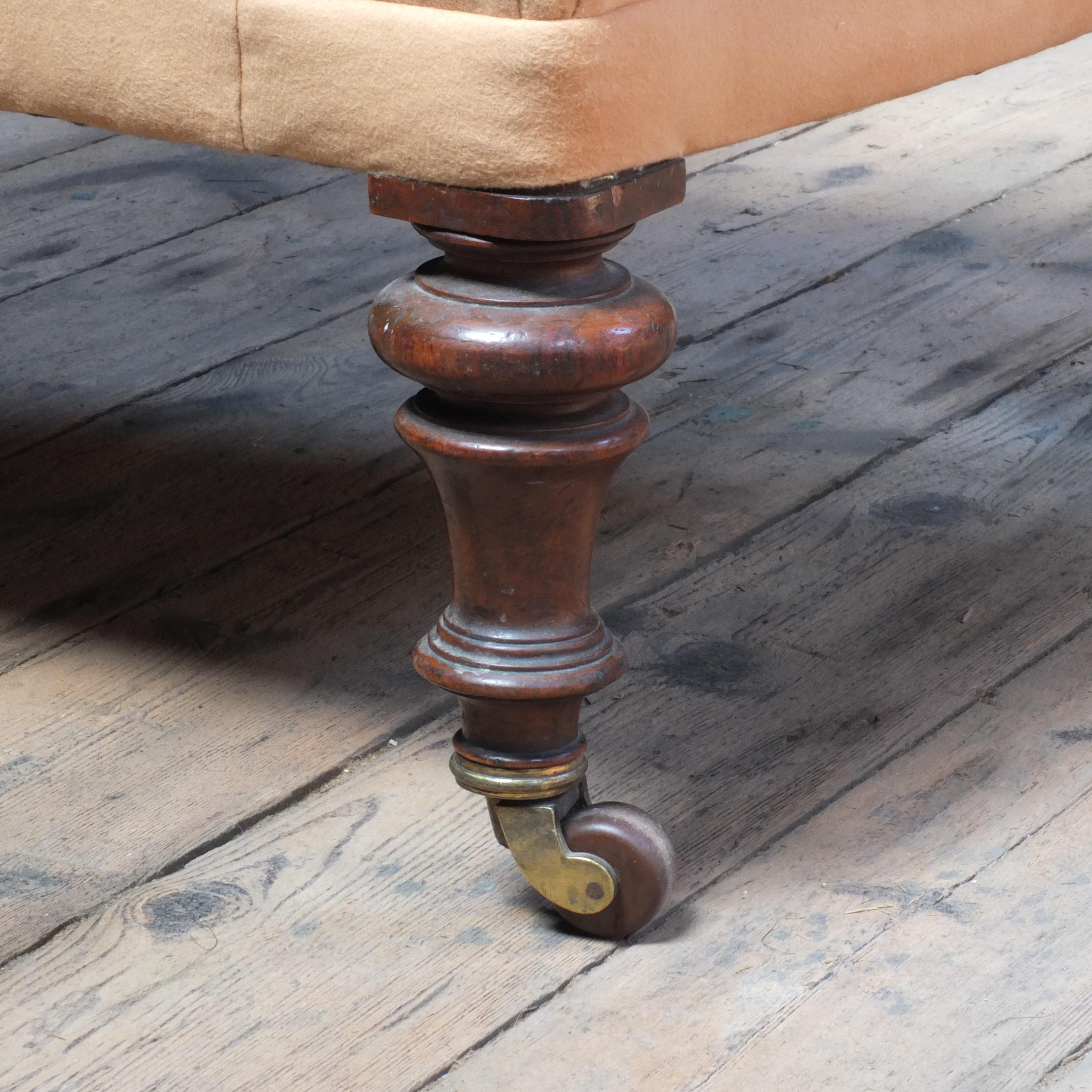 A very well proportioned 19th century arm chair by Constantine & Co of Leeds, West Yorkshire. sitting on well turned walnut legs with the original large Cope Collision brass and ceramic castors. The original paper label inside the frame underlining