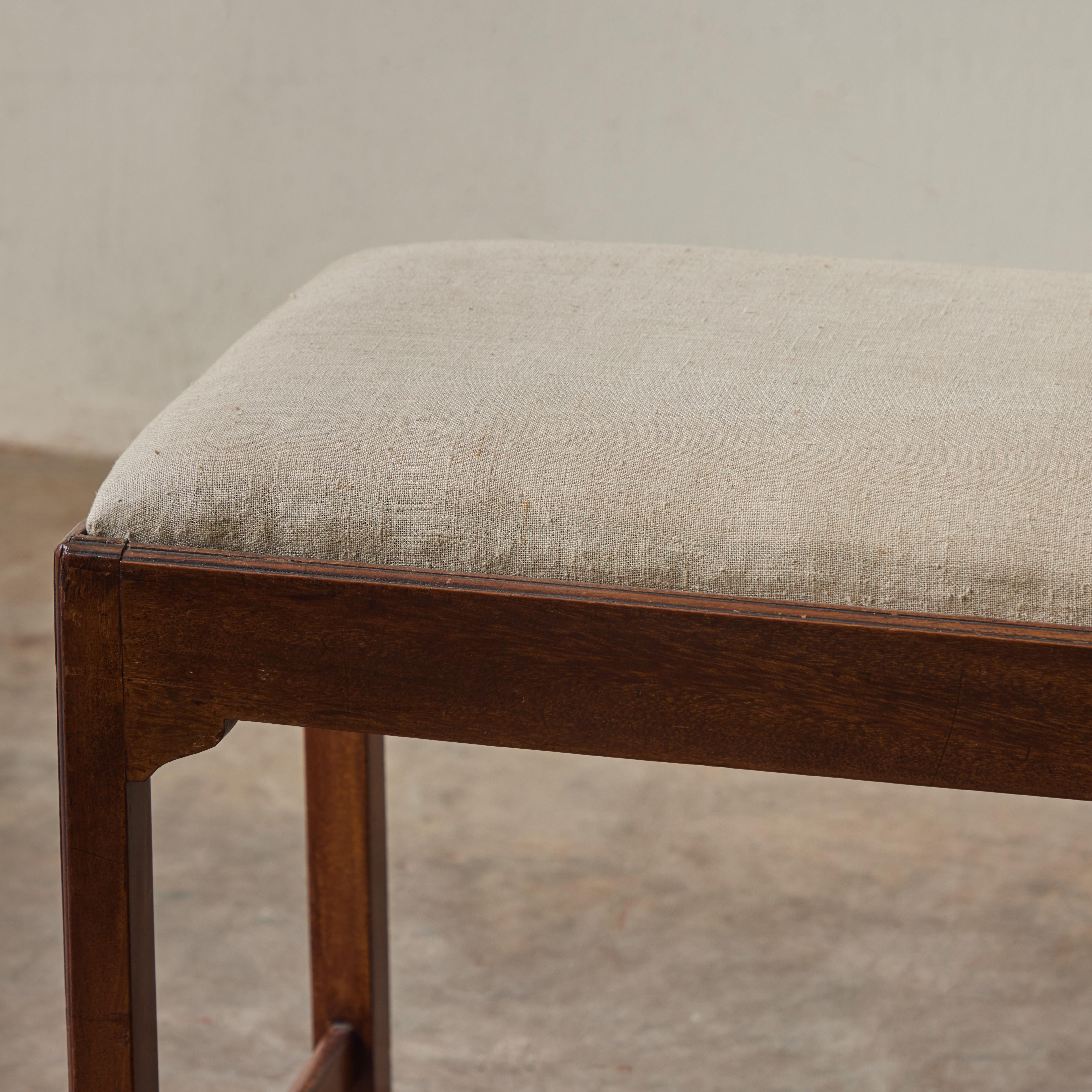 English Arts and Crafts wooden bench from the 1860s, with a beautiful cream colored linen upholstered cushion. With its retrained elegance, the piece has a wonderfully understated, timeless appeal. 

England, circa 1860

DimensionsL 30W x 15D x