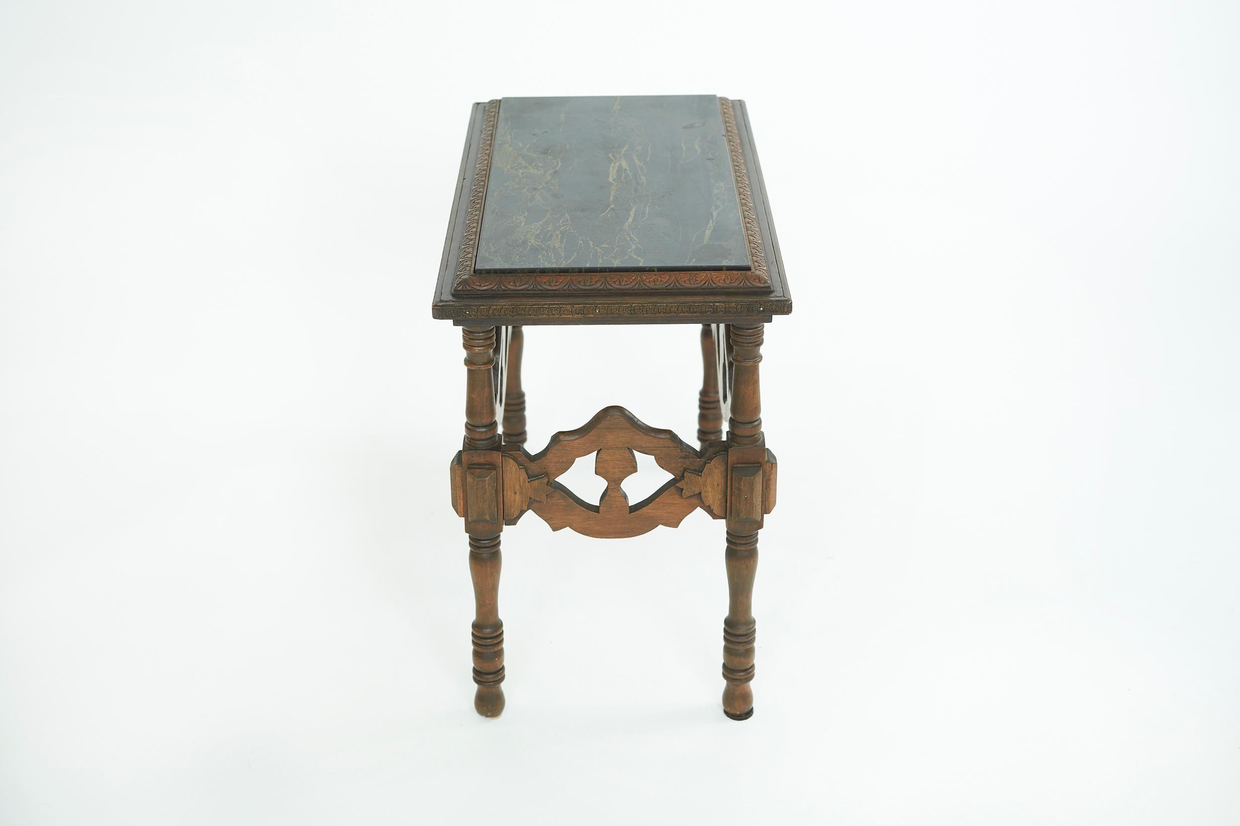 Beautiful English arts and crafts with marble inserted side table, on rounded legs with scroll feature & geometric rectangle trim features an intricate foliate design. The table is in good condition. Minor wear consistent with age / use. The table