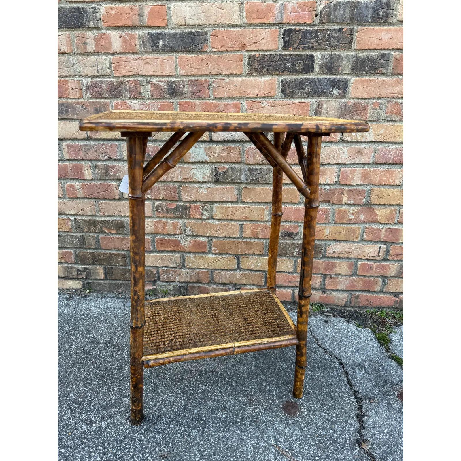 This is a beautiful all original 19th century English bamboo side table! Tables like these make excellent accent pieces because their color and style is so versatile. The dark hues of the burnt bamboo pair perfectly with the lighter golden of the