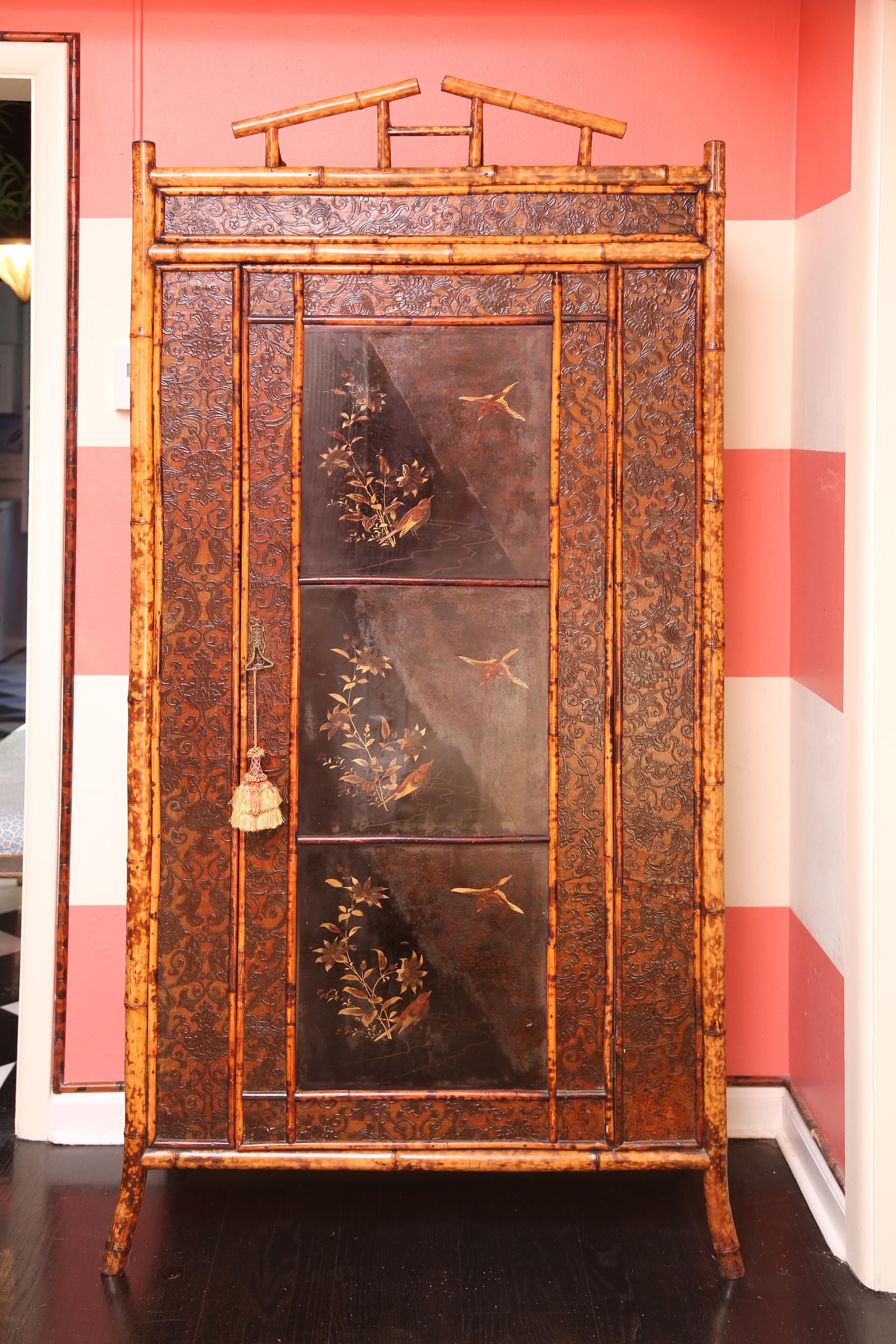 19th century English bamboo armoire with Japanning and leather paper with five shelves inside.