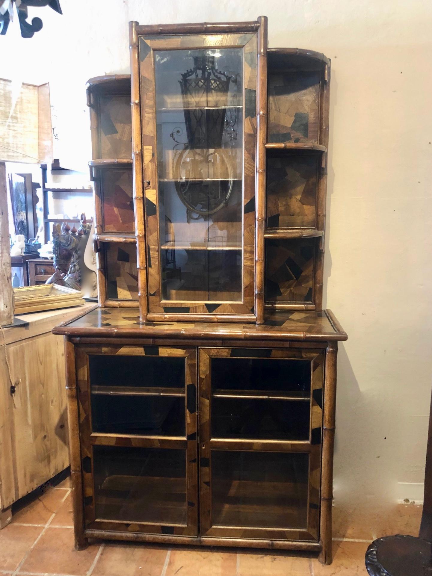 This is a superb quality original antique bamboo bookcase with 2 doors below and one above.
In the arts and crafts style. Highly unusual in style, form, and large in scale.
There are many pieces of inlaid wood ranging from ebony, oak, pollard oak,