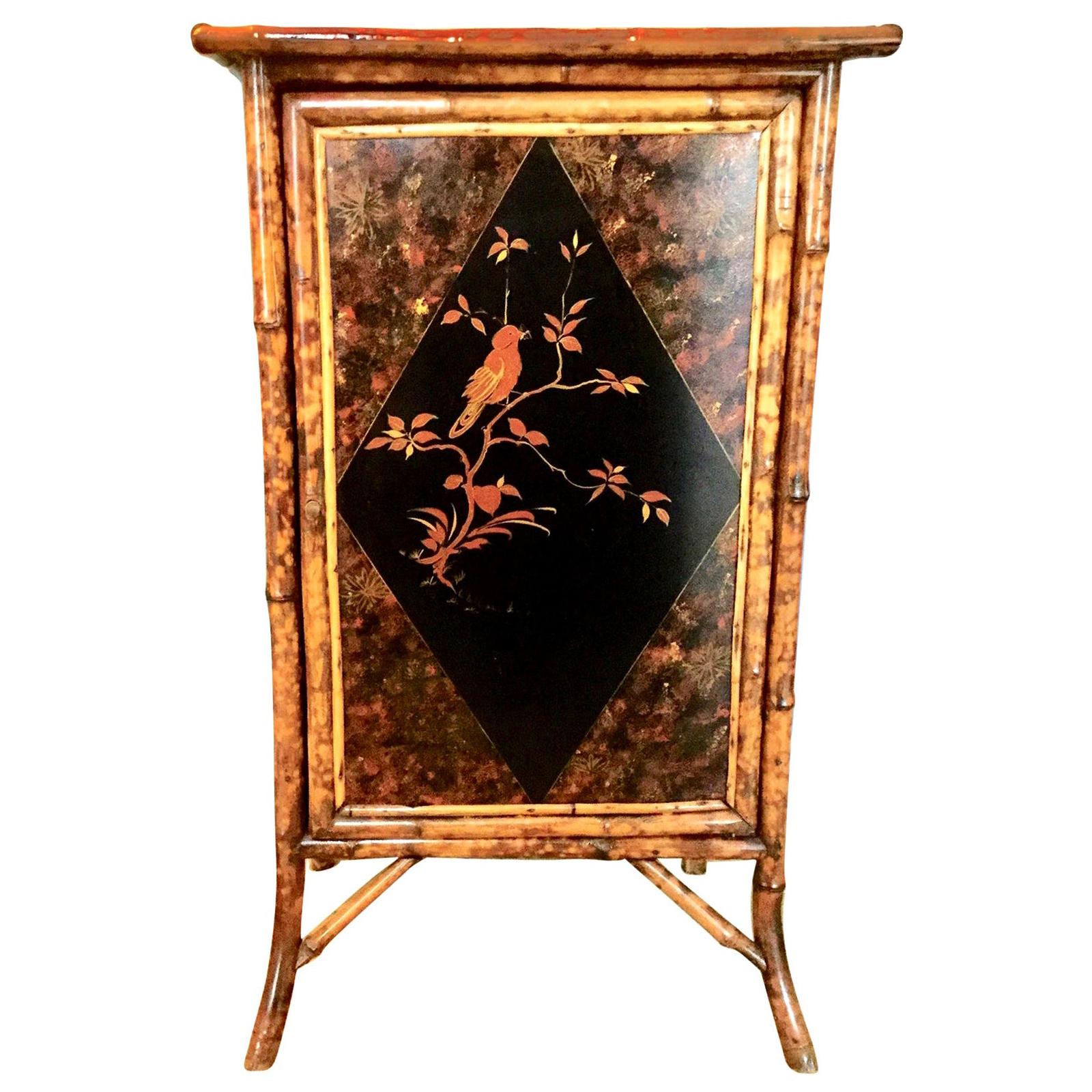 Lovely 19th century English bamboo cabinet with chinoiserie panels on three sides and the top. Beautiful motif’s of birds and floral lacquered panels on all three sides and top. The inside has three areas with shelves in between.
A great focal