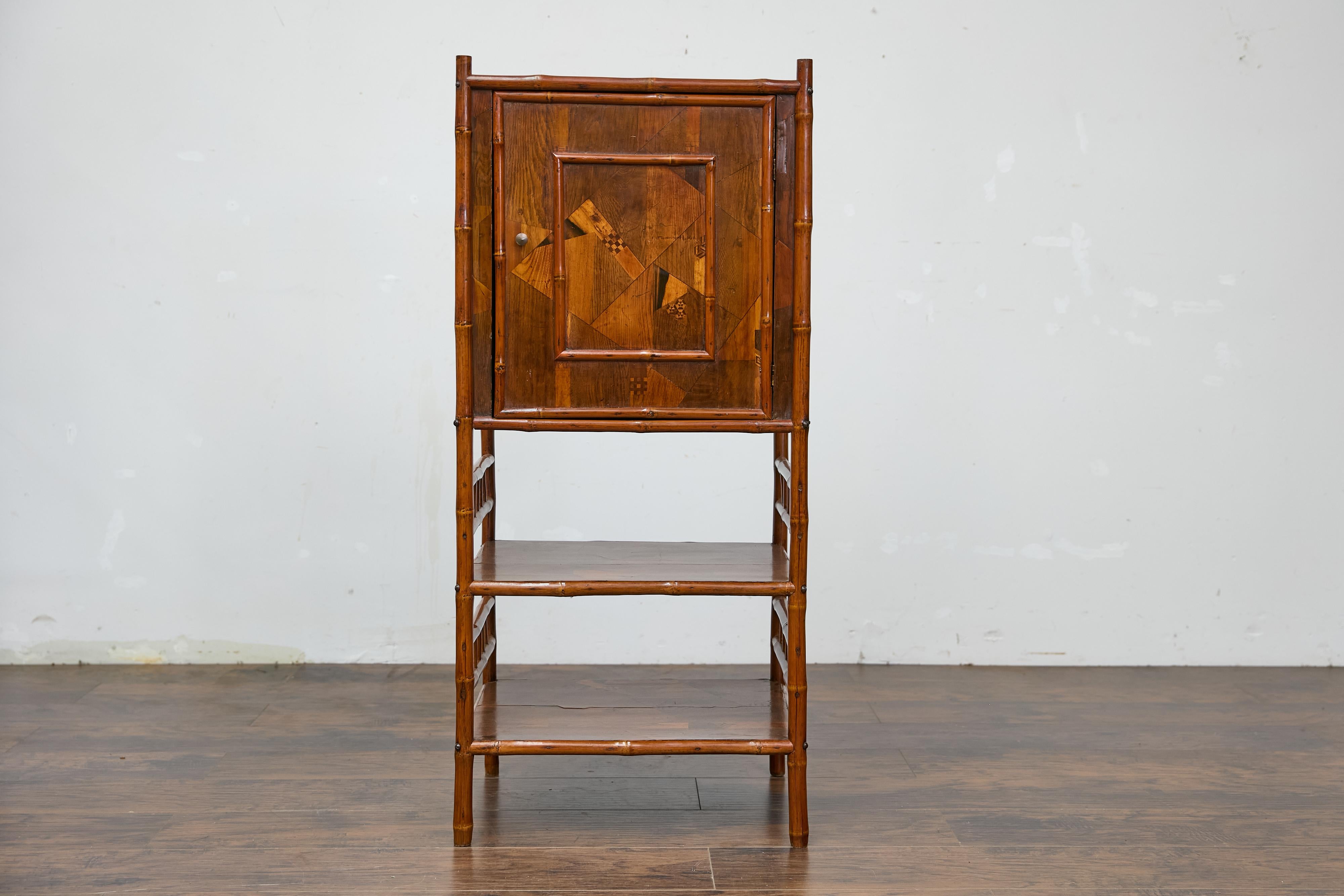 A 19th century English bamboo bedside cabinet from the 19th century with parquetry décor. This 19th-century English bamboo small cabinet exudes charm with its intricate design and timeless appeal. The frame, crafted from bamboo, adds a warm, organic