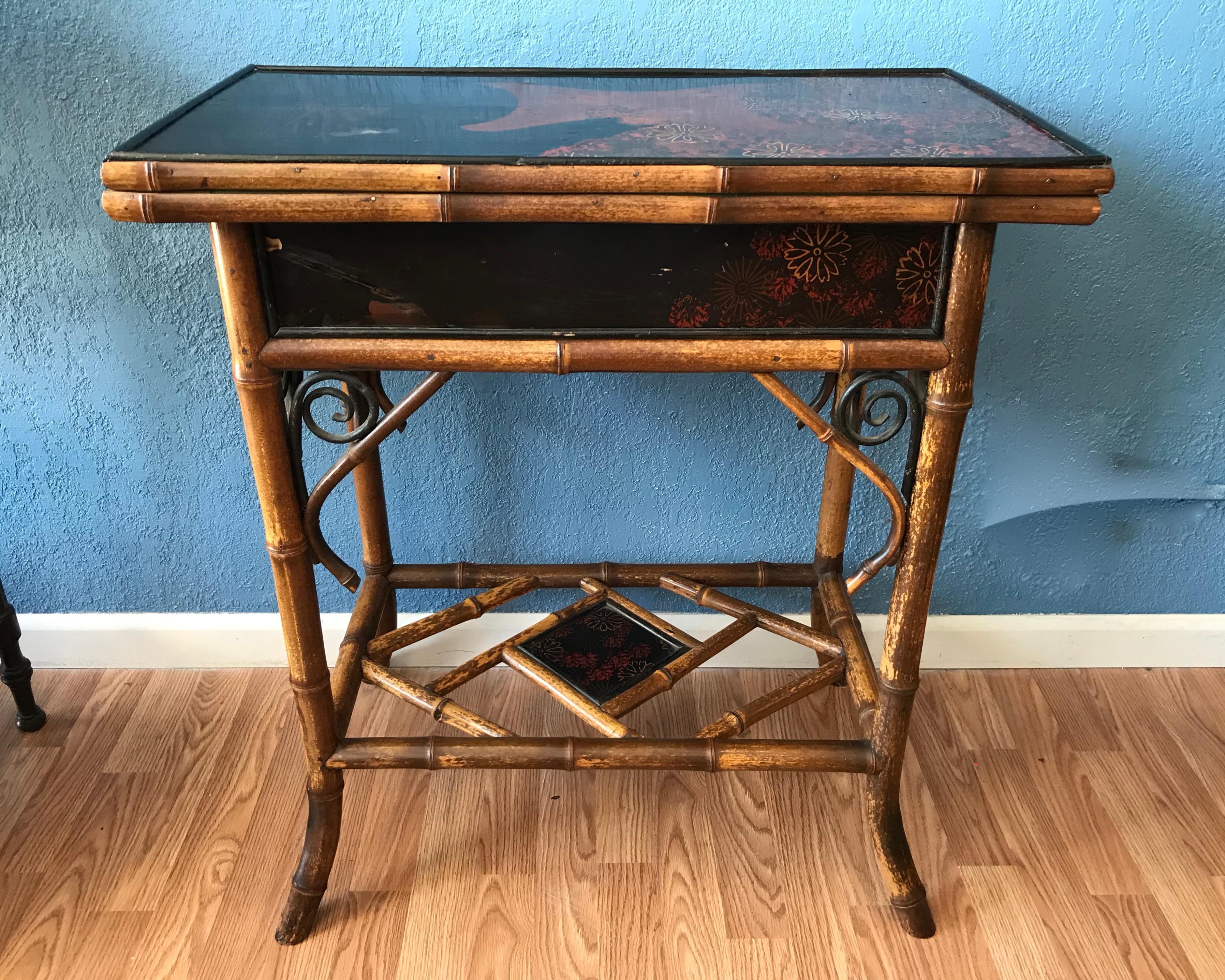 The table is fashioned with a lovely flip lacquered top decorated with florals.
The side panels are adorned with root appointments.
The game table top is fitted with felt. The interior can hold game pieces and cards.
The open table top measures