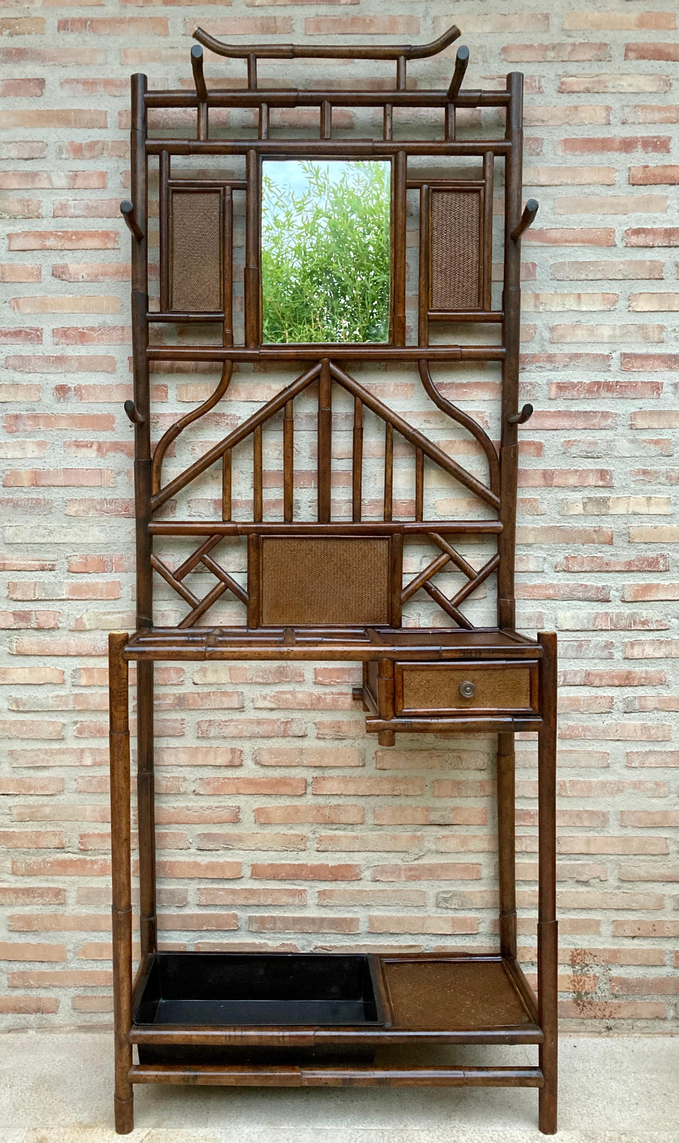 Vintage design
19th century English bamboo hall stand.
Entrance cabinet with umbrella stand, mirror, coat rack and rack
Chippendale style of bamboo and rattan. Very popular in late 19th century England and now trending again.

Exotic and