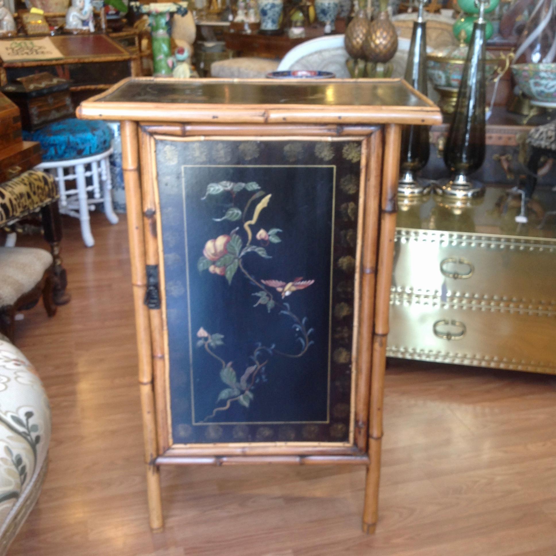 A charming piece with hand painted lacquered panels front and top 
depicting birds in flight in the midst of florals.
An attractive design and scale.