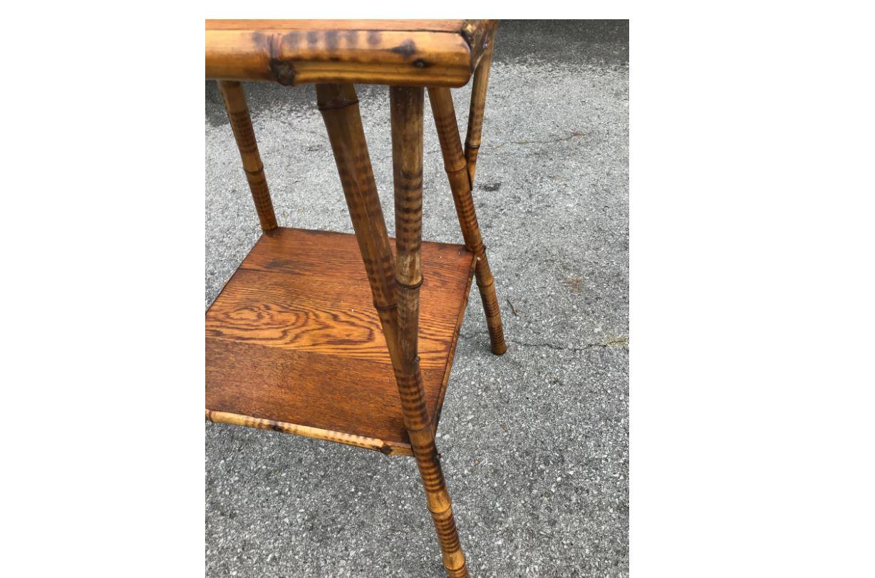 A wonderful 19th century English Bamboo side table. It features an oak table top that adds so much uniqueness to this piece! It would be a marvelous addition to any room.