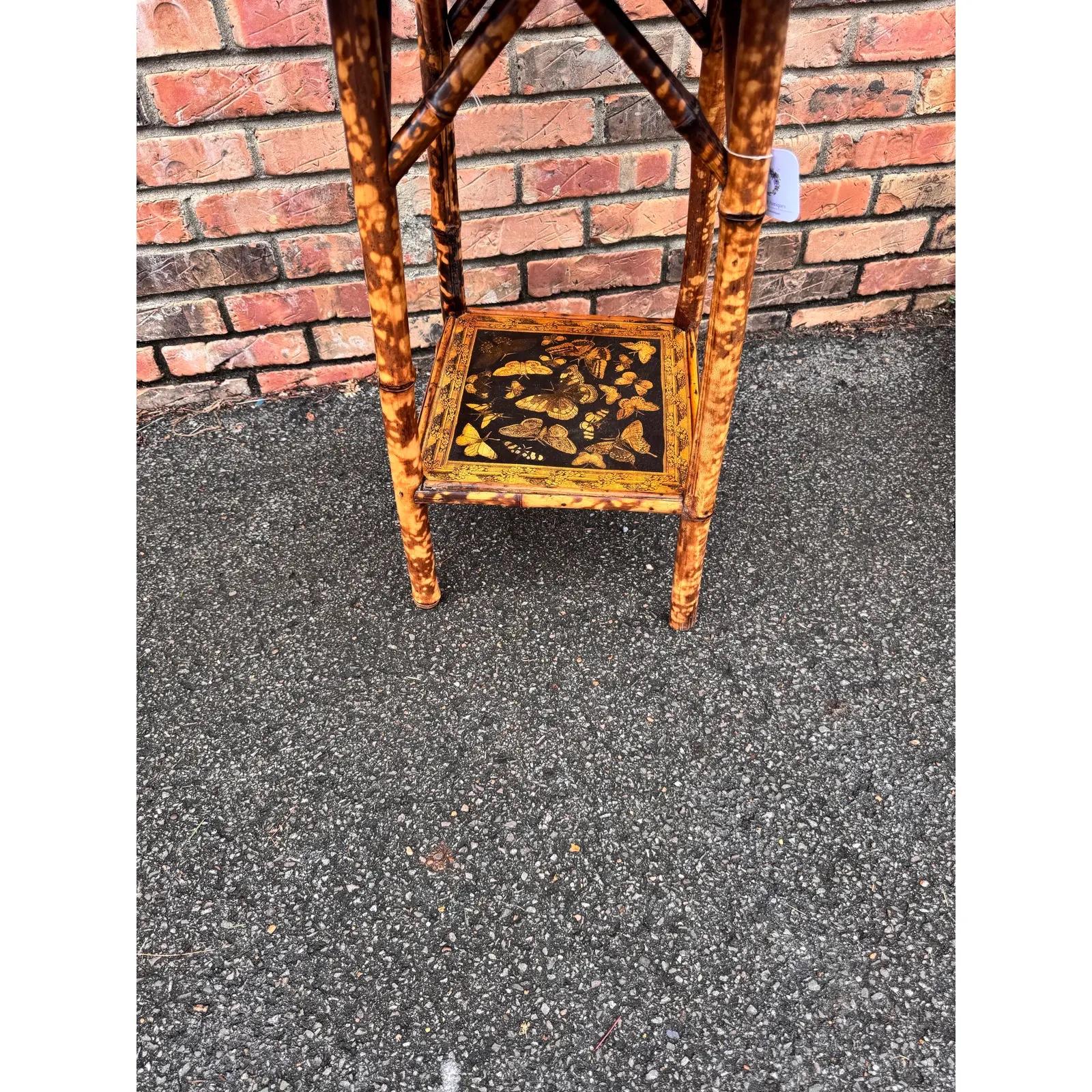 This is a beautifully decoupage English bamboo side table octagon in shape. The yellow of the butterflies against the black background in combination with the burnt bamboo gives this table, such a great appearance. English bamboo is very popular and
