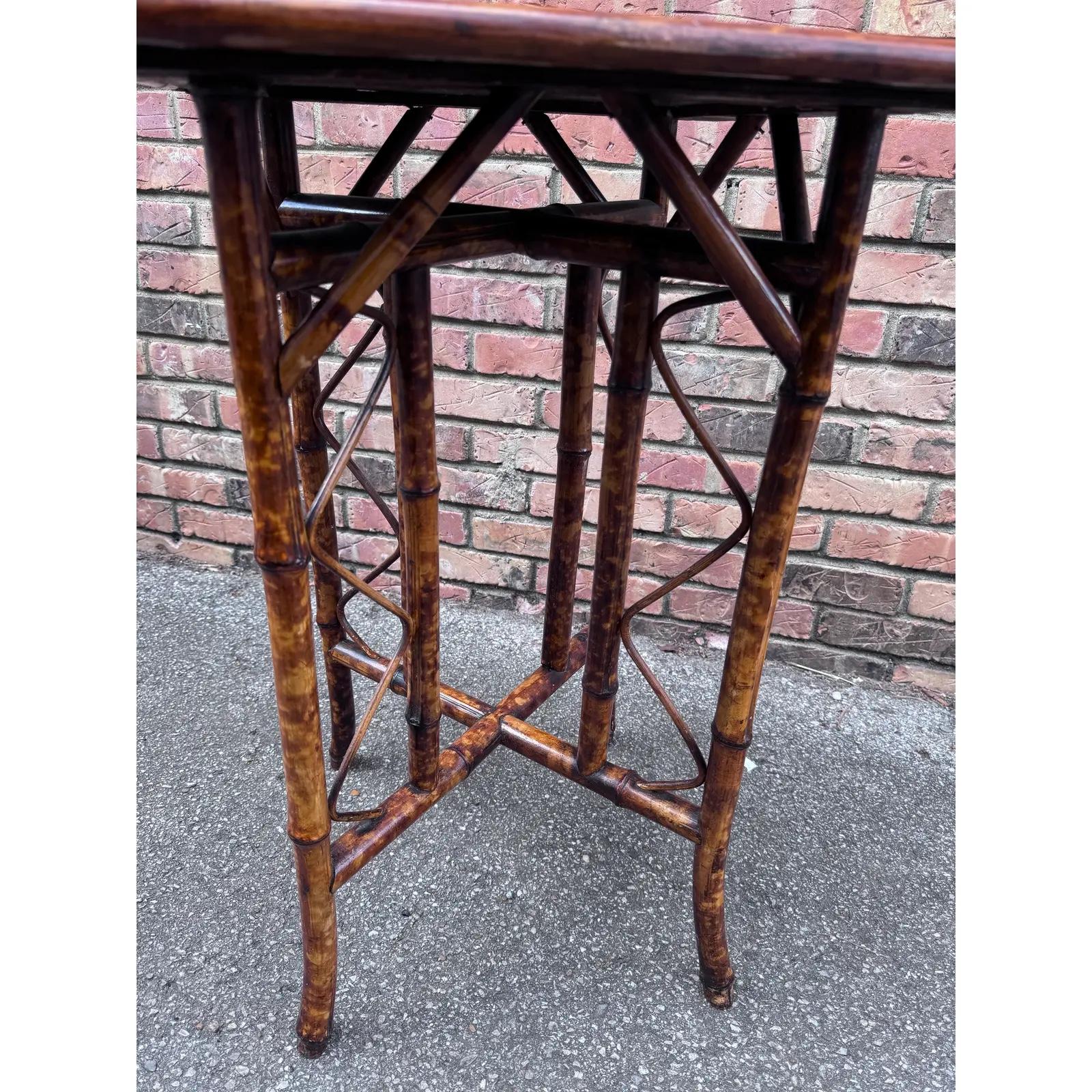 This beautiful bamboo side table heralds from the English Aesthetic movement and features a unique chinoiserie themed hand painted top with black and deep oranges.
This could make a sweet guest bedroom side table, lamp, chairside or display table.