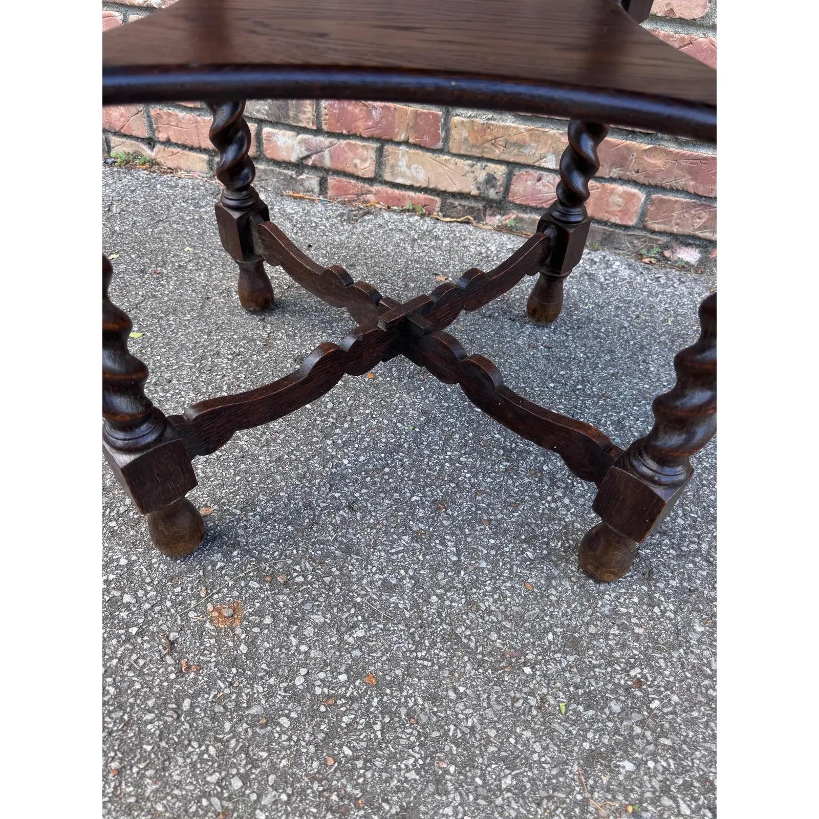 This is a very unique English side table for such a small piece. It has an incredible amount of detail Barley twist legs which is an English tradition a center shelf and beautifully crafted stretchers below that. As normal with the good barley twist