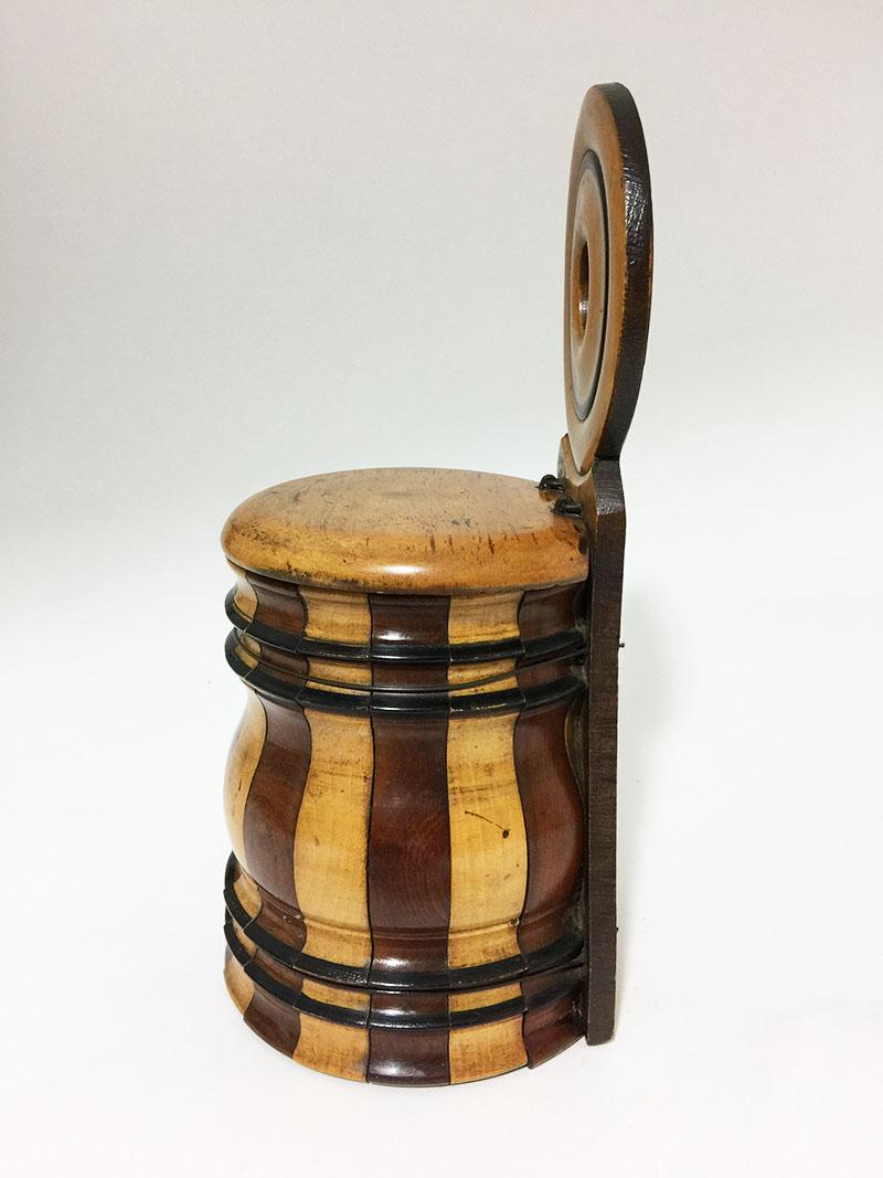 19th century English barrel shaped wall mounted salt box

A 19th century English curved wood wall mounted salt box/ jar in light colored wood and mahogany strips 
1830-1850
The body and lid held together by original wiring
Has a small