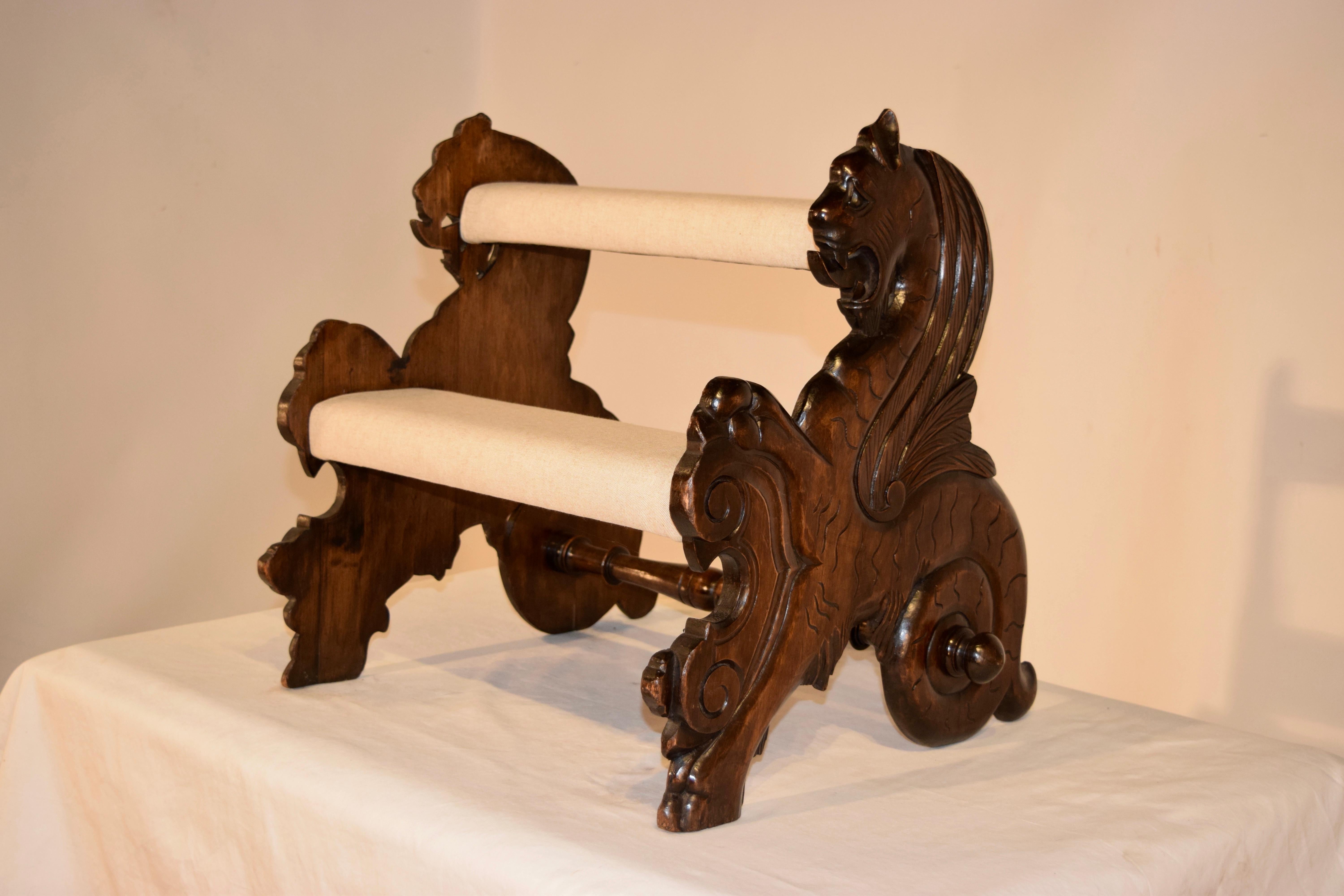 19th century mahogany bed steps from England. The sides are hand carved and decorated Gryphons and are joined by steps, which have been newly upholstered in linen.