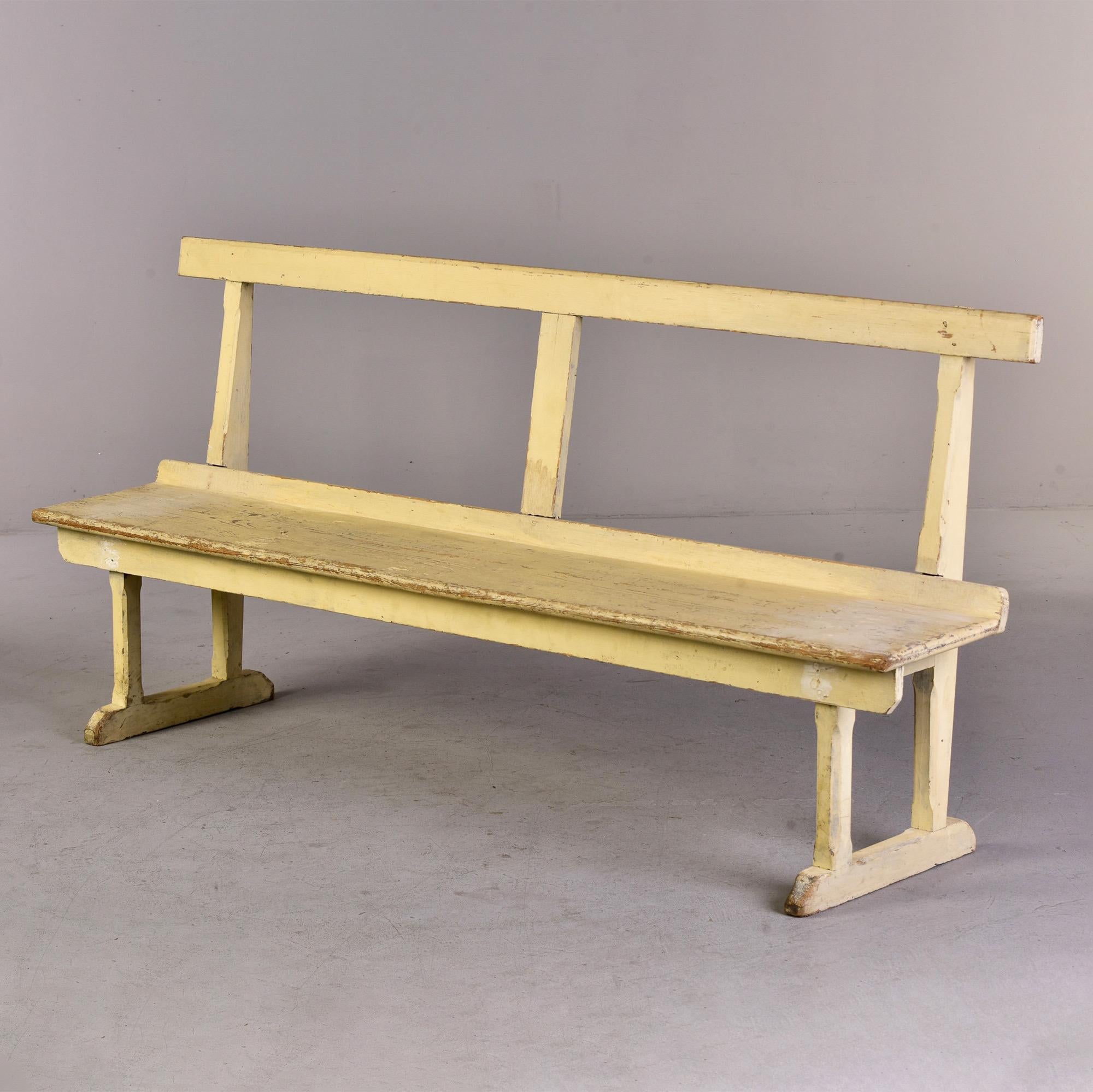 Circa 1880s English slender wooden bench with pale, butter yellow painted finish. Two benches in this size and finish available at the time of this posting. Sold and priced individually. 

Measures: Seat height: 16” seat depth: 11.5”.
    